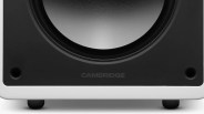 Close-up of a black and white speaker base with the word "CAMBRIDGE" on the front panel.