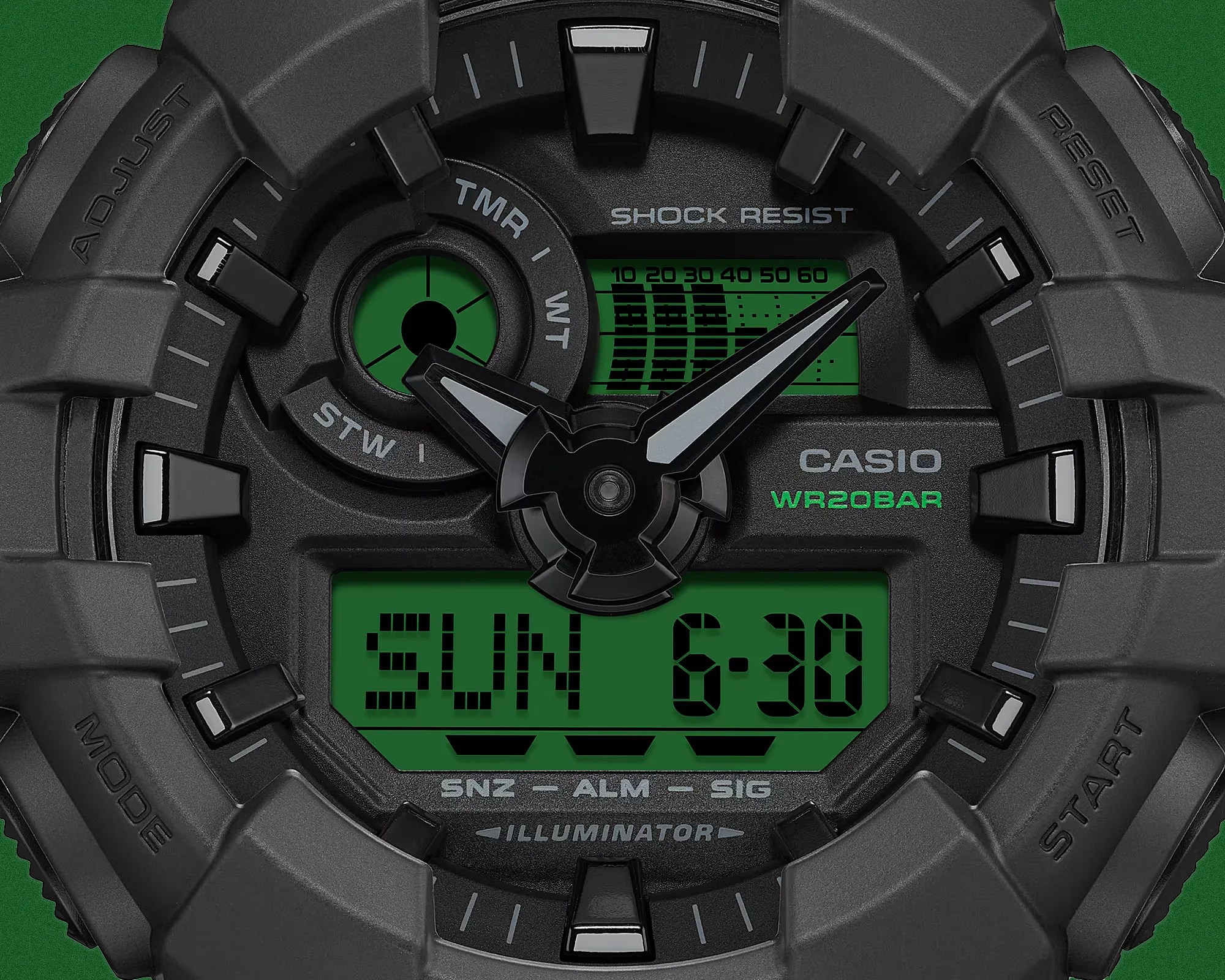 Close-up of a black Casio digital-analog watch face with green digital displays and white hour and minute hands.