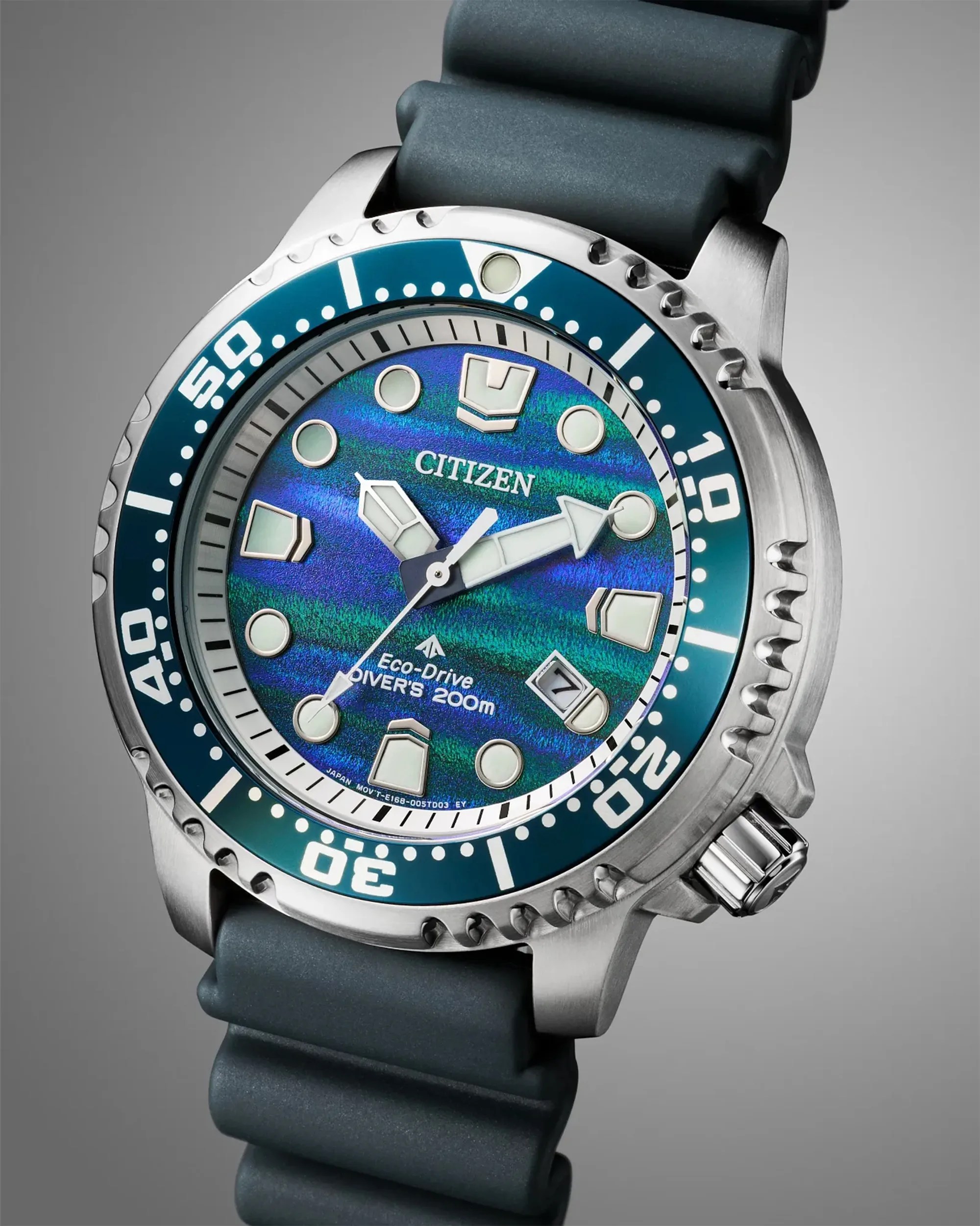 Citizen Eco-Drive diver's watch with blue-green iridescent dial, stainless steel case, and black rubber strap.