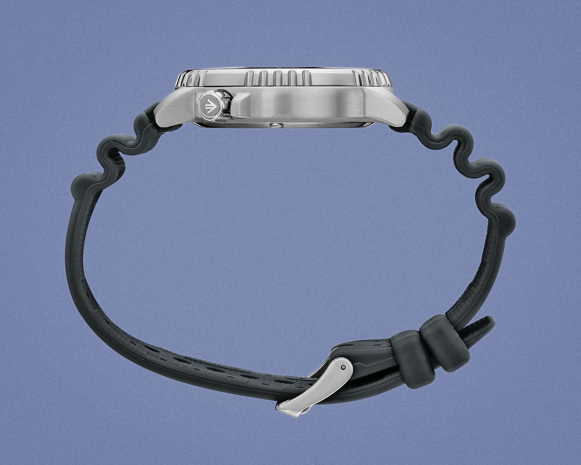 Side view of a silver metal watch case with a black wavy rubber strap and a silver buckle on a blue background.