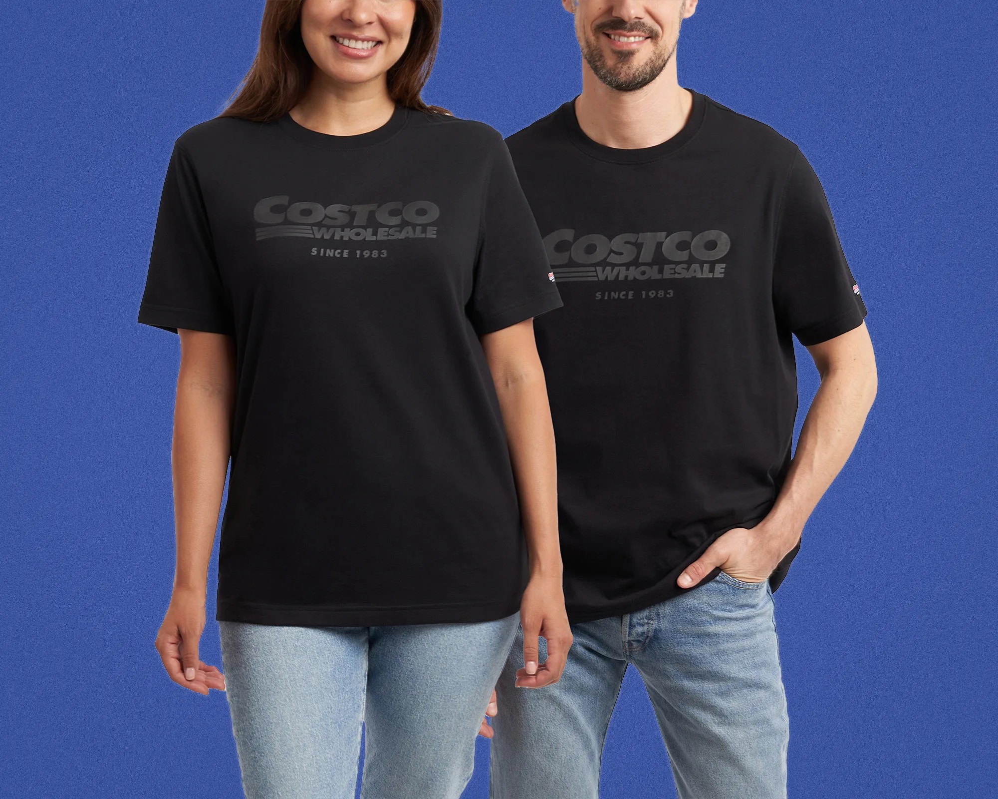 Two people wearing black Costco Wholesale logo T-shirts and light blue jeans against a blue background.