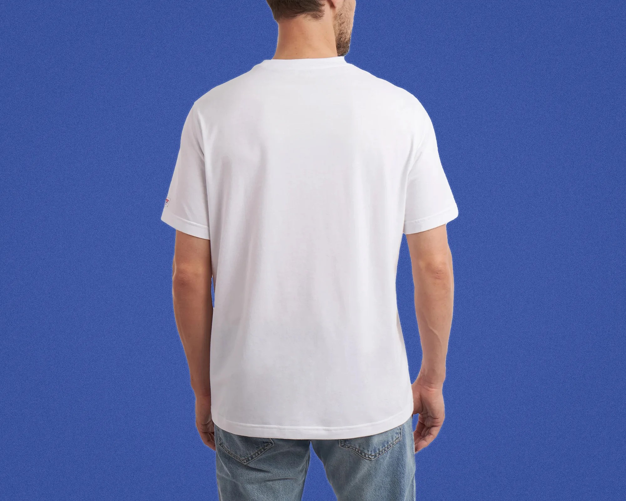 White short-sleeve T-shirt worn by a person facing away against a blue background.