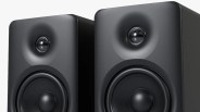 Pair of black rectangular speakers with rounded edges and visible tweeters and woofers.