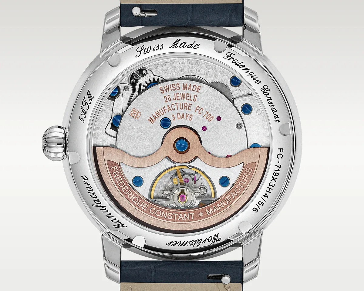 Back view of a Frederique Constant watch showing the mechanical movement with 26 jewels, rose gold rotor, and blue screws inside a stainless steel case.