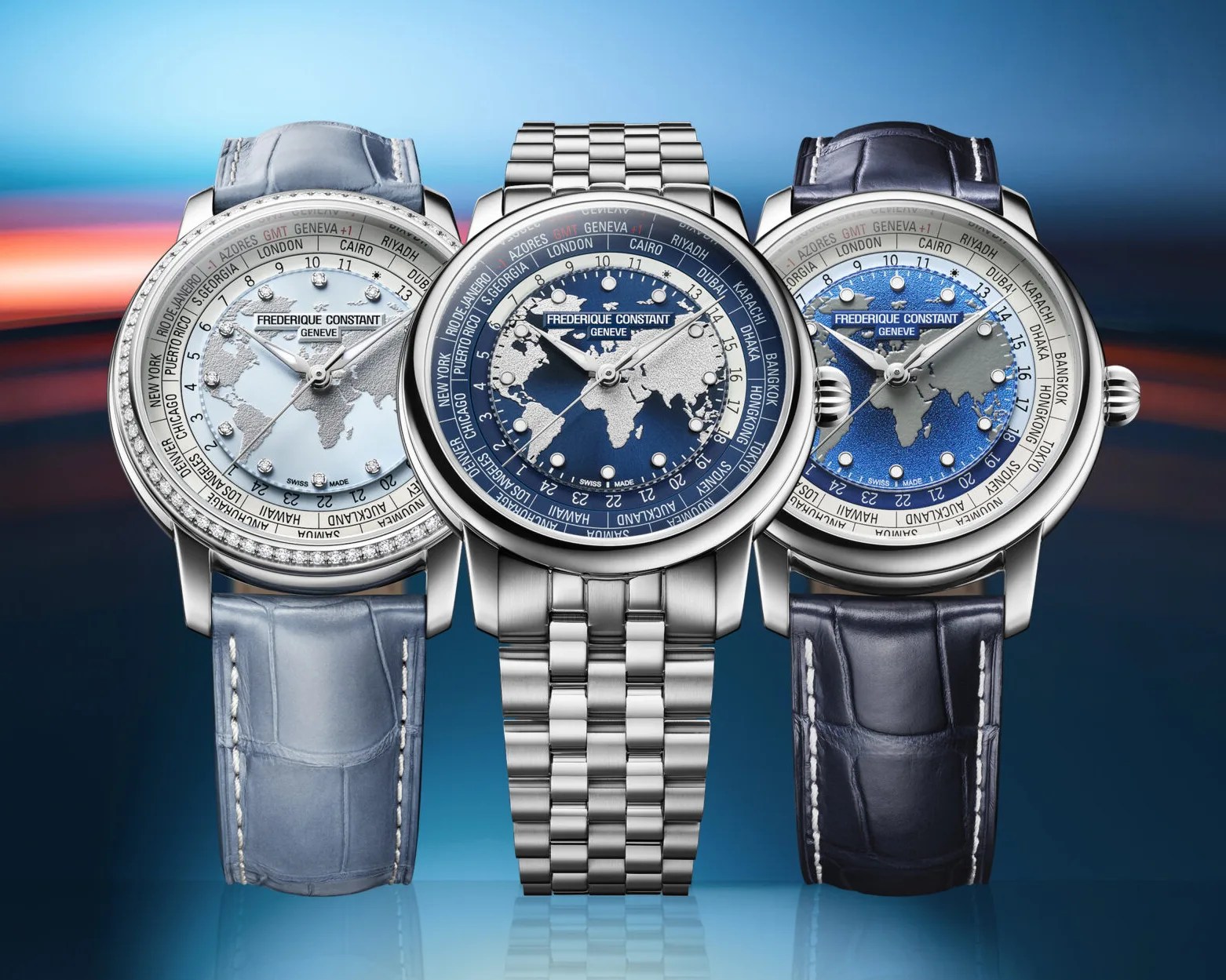 Three Frederique Constant wristwatches with world map dials, two with leather straps in light and dark blue, and one with a silver metal bracelet.