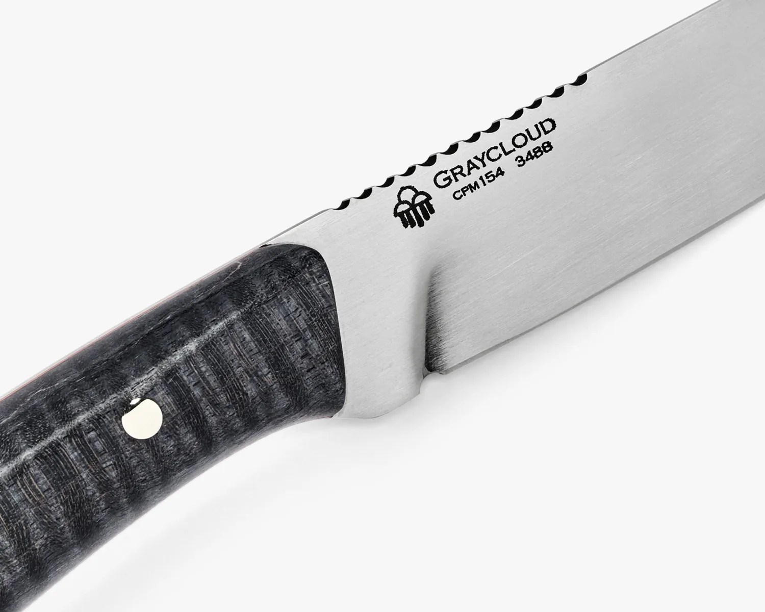Close-up of a Graycloud CPM154 348B knife blade with a textured dark handle and scalloped spine.