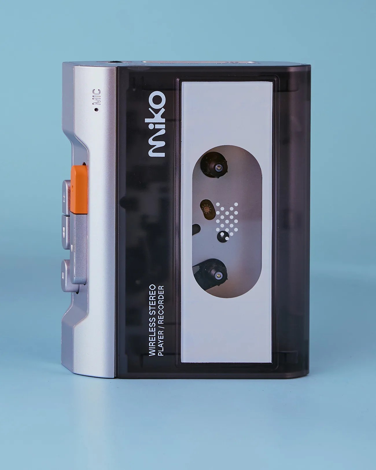 Silver and black Miko wireless stereo cassette player/recorder with orange button on a blue background.