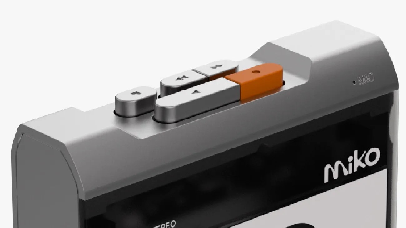 Close-up of a gray Miko cassette player with silver and orange control buttons on top.