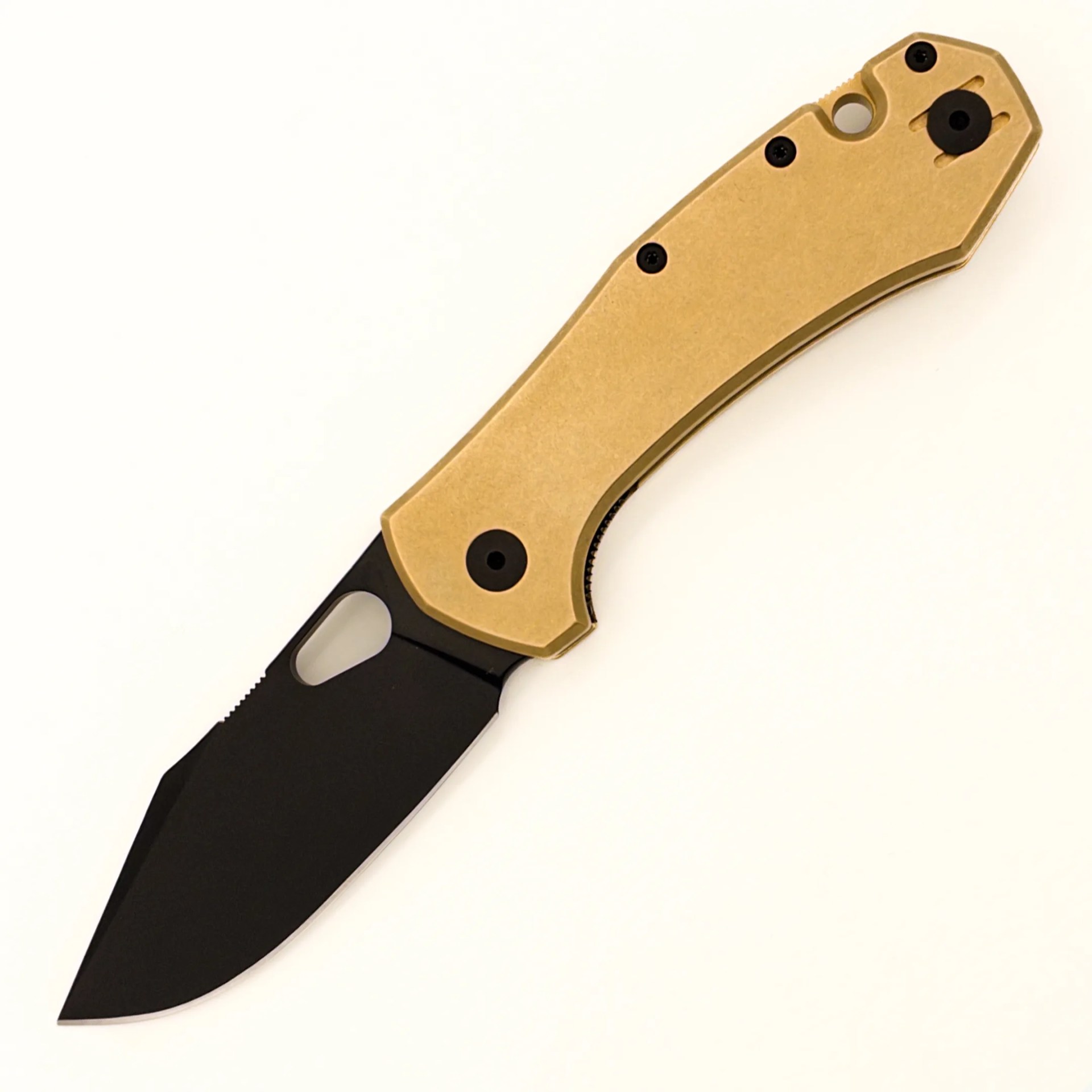 Folding knife with black tanto blade and tan textured handle on white background.