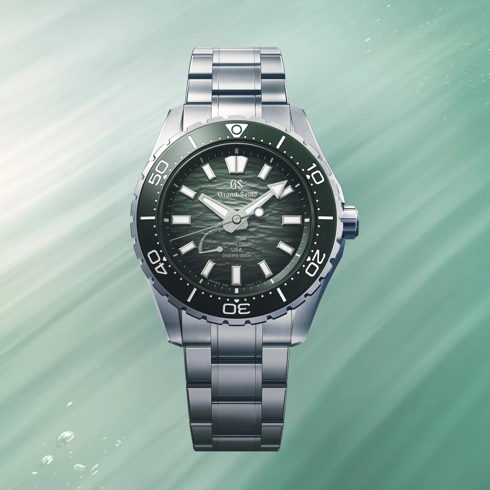 Silver stainless steel Grand Seiko diver's watch with textured dark green dial and black bezel.