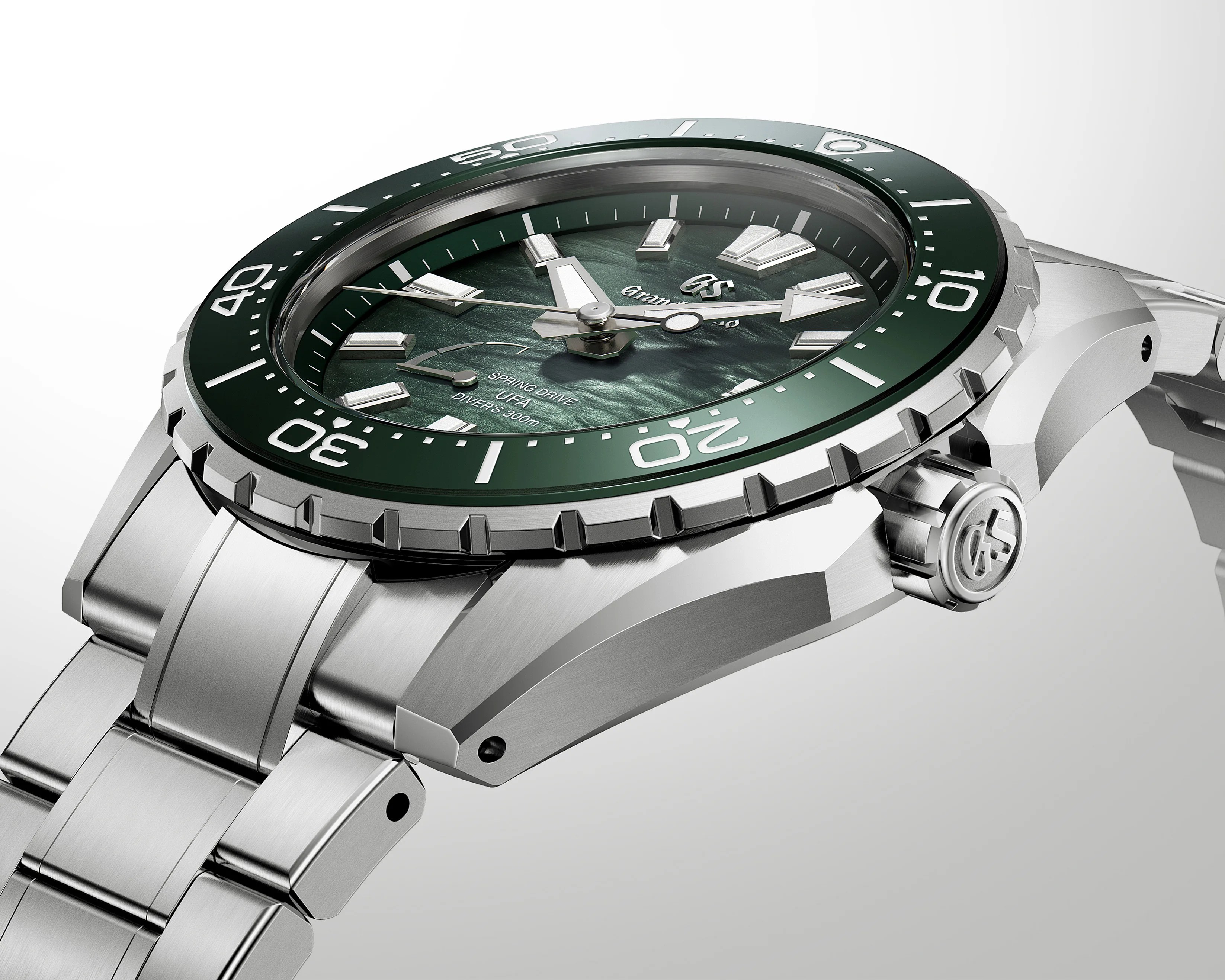 Silver stainless steel dive watch with green bezel and textured green dial showing "Spring Drive" and "Diver's 200m" text.
