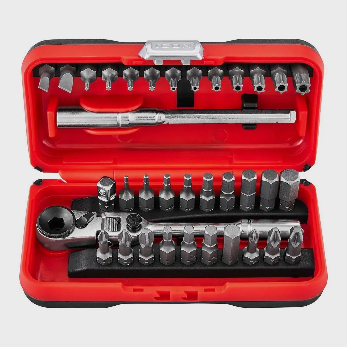 Red and black compact tool case with a ratchet wrench and multiple metal screwdriver and hex bits.