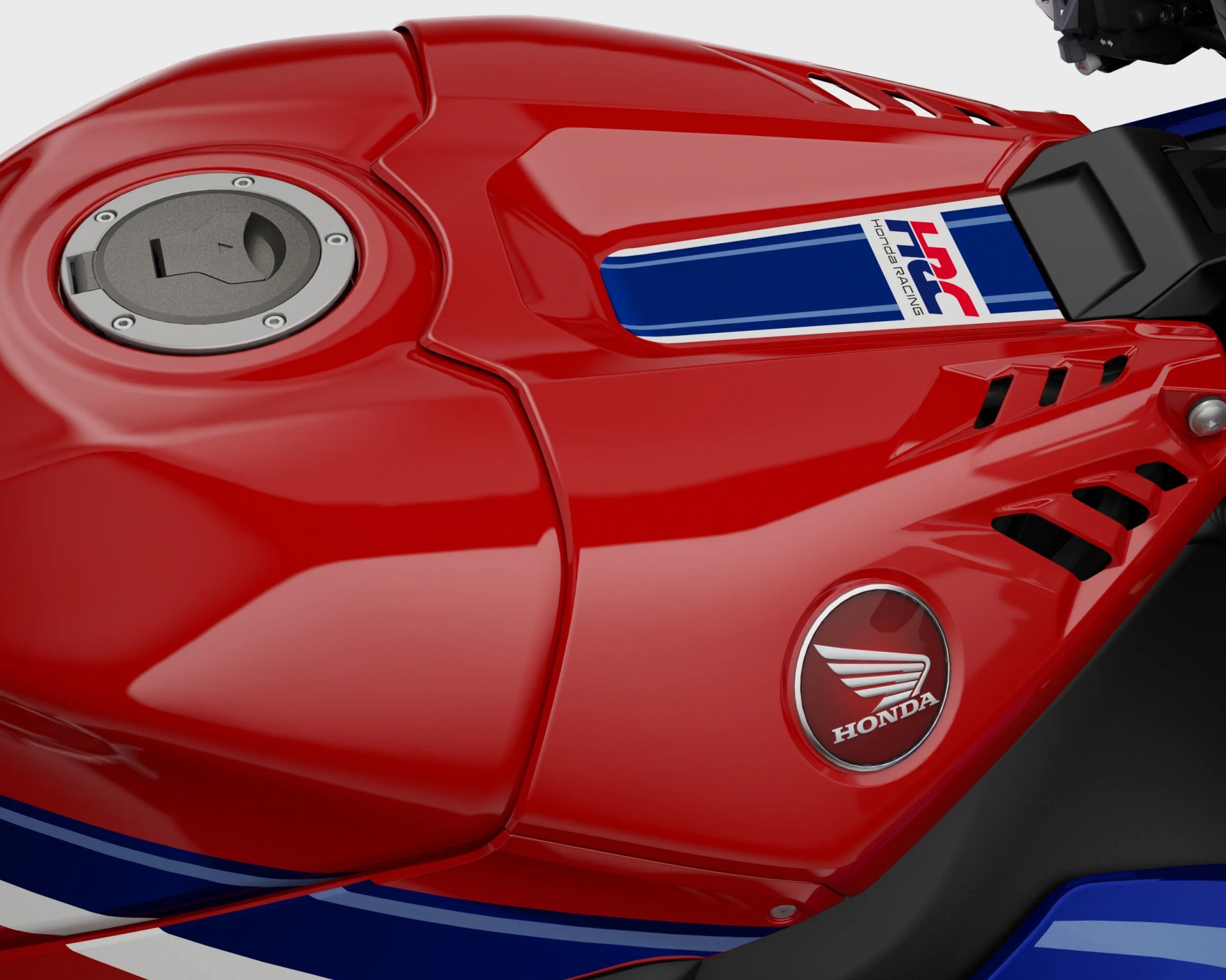 Glossy red motorcycle fuel tank with Honda wing logo and HRC Honda Racing decal.