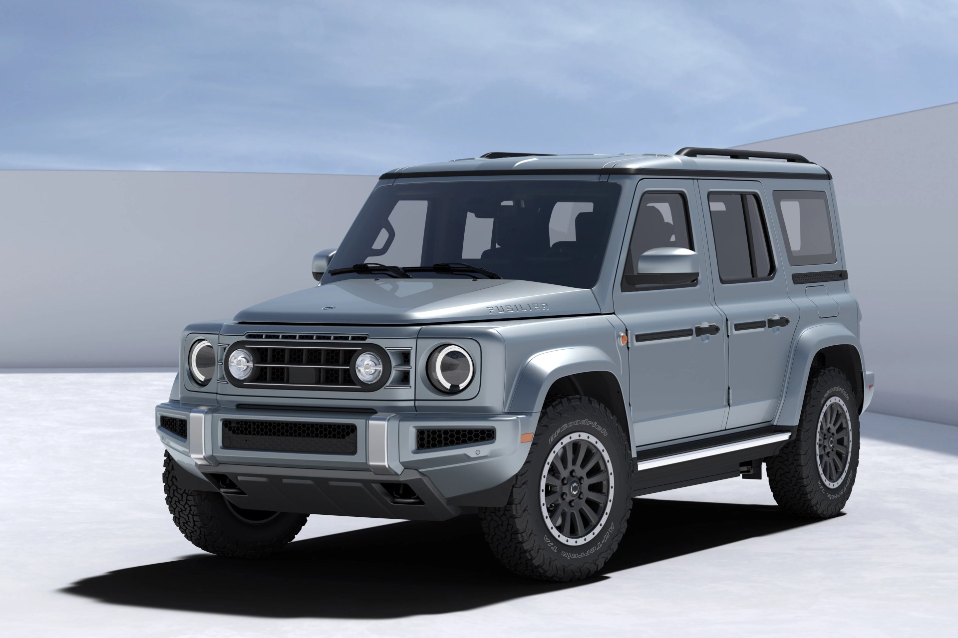 Light blue four-door off-road SUV with rugged tires and round headlights in a minimal outdoor setting.
