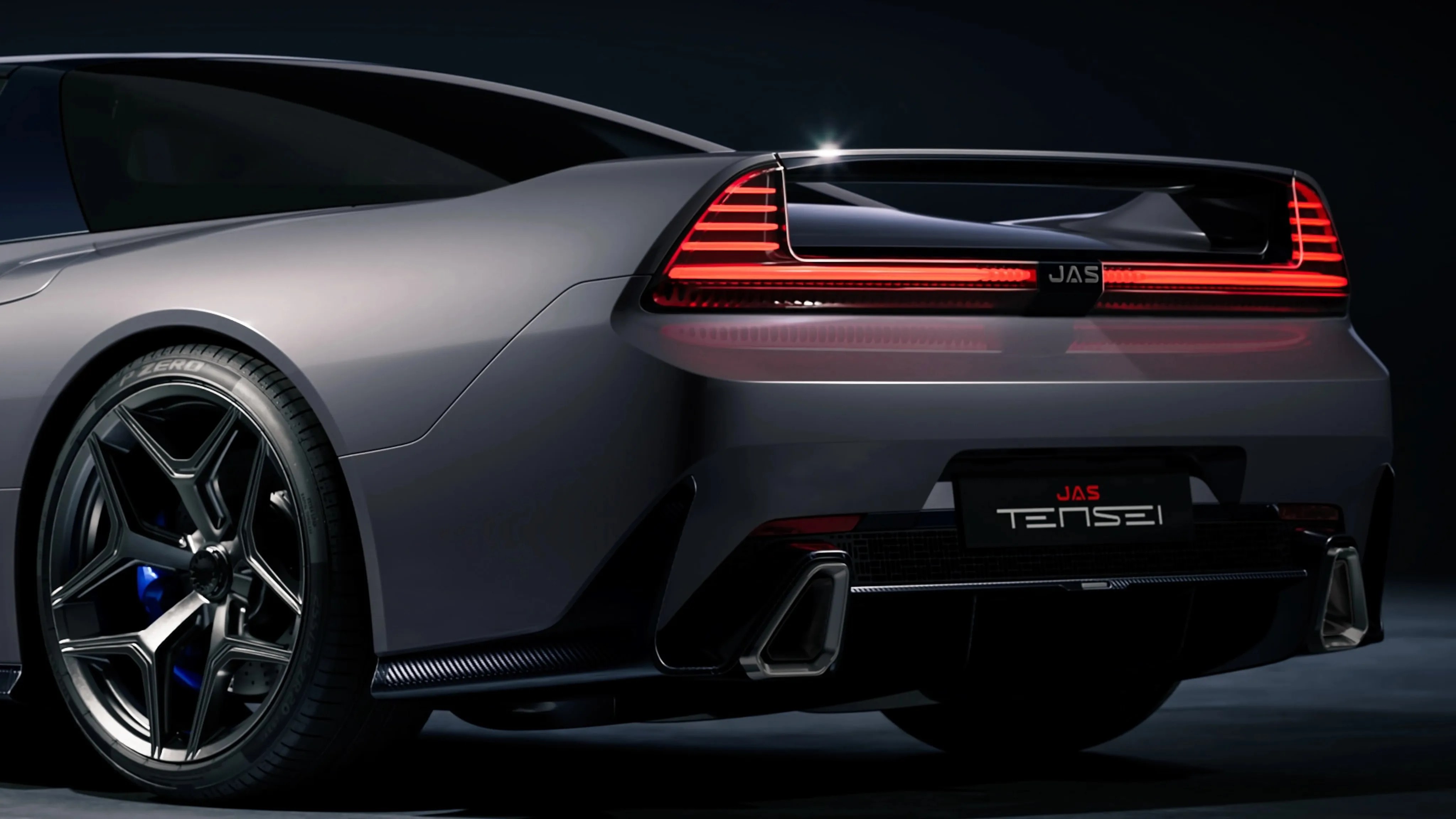 Rear view of a gray JAS Tensei sports car with illuminated horizontal taillights and black alloy wheels.