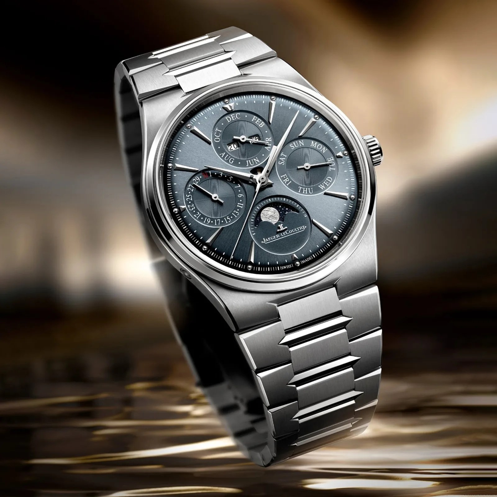 Stainless steel Jaeger-LeCoultre wristwatch with blue dial featuring moon phase, day, date, and month subdials.
