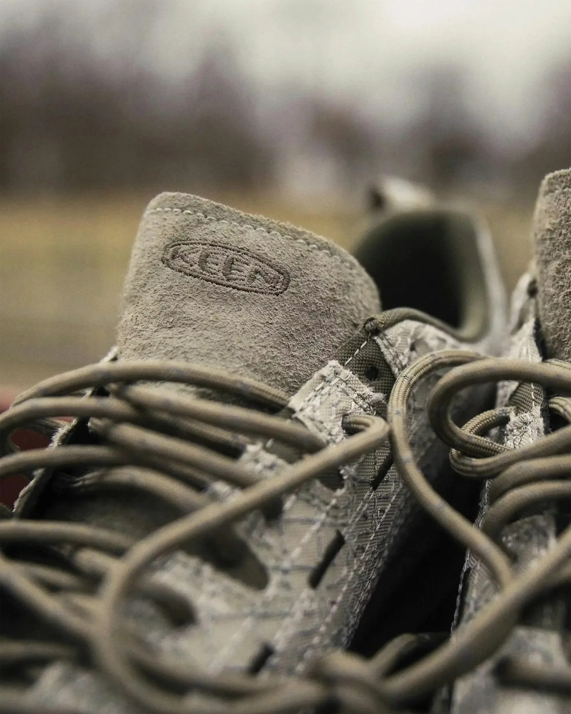 Close-up of beige suede Keen shoe tongue with laces and textured fabric sides.