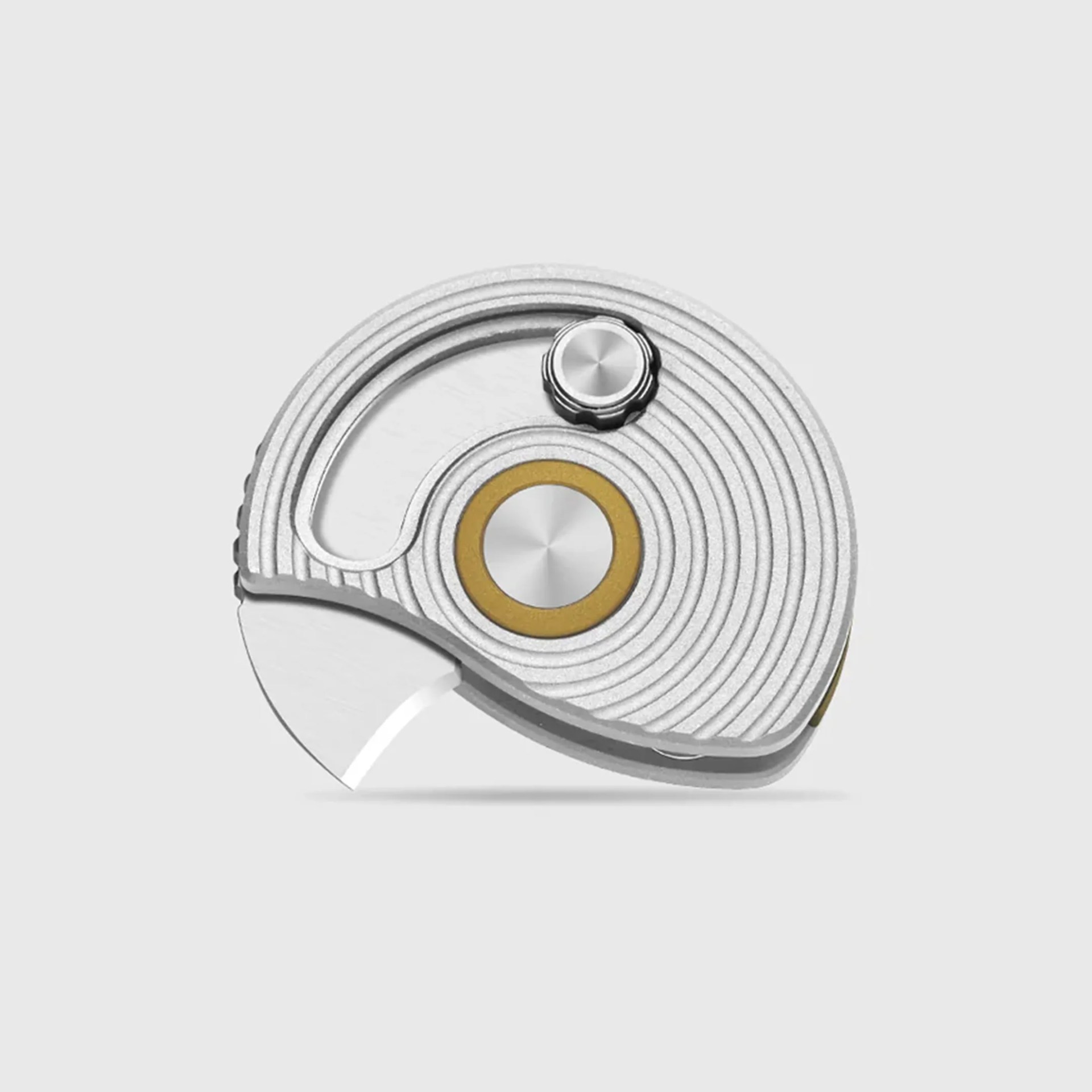 Silver circular folding utility knife with concentric grooves and a small round knob on top.