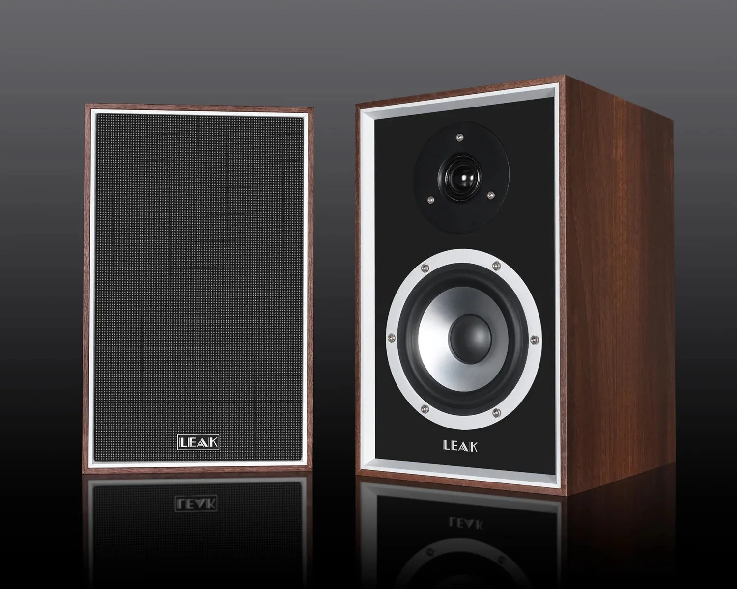 Pair of vintage-style bookshelf speakers with wooden cabinets, one with black grille and the other showing silver woofer and tweeter.