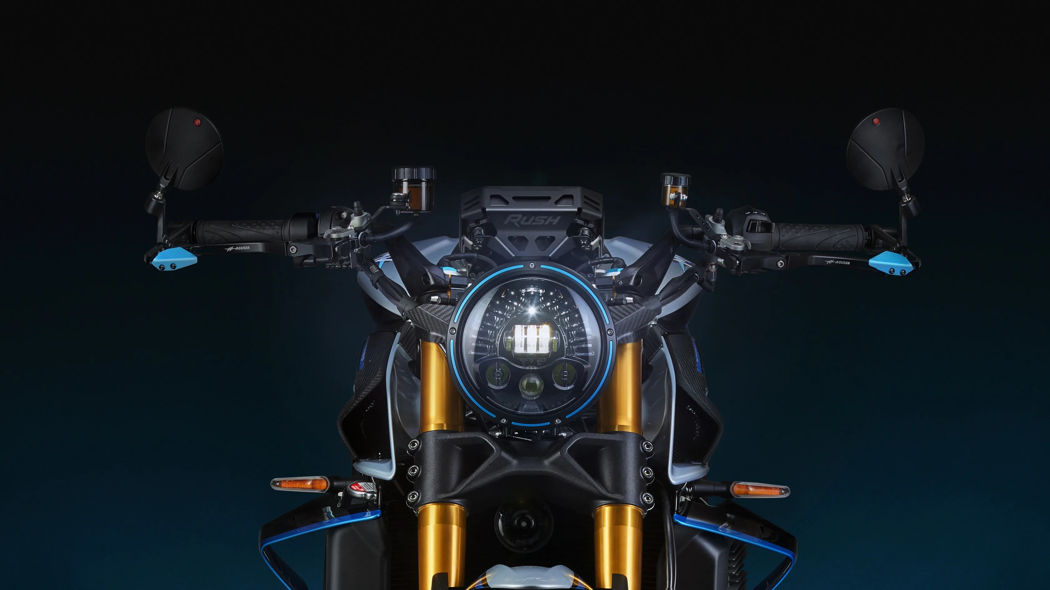 Front view of a motorcycle headlight with gold front forks, round LED light, and black handlebars with blue accents.
