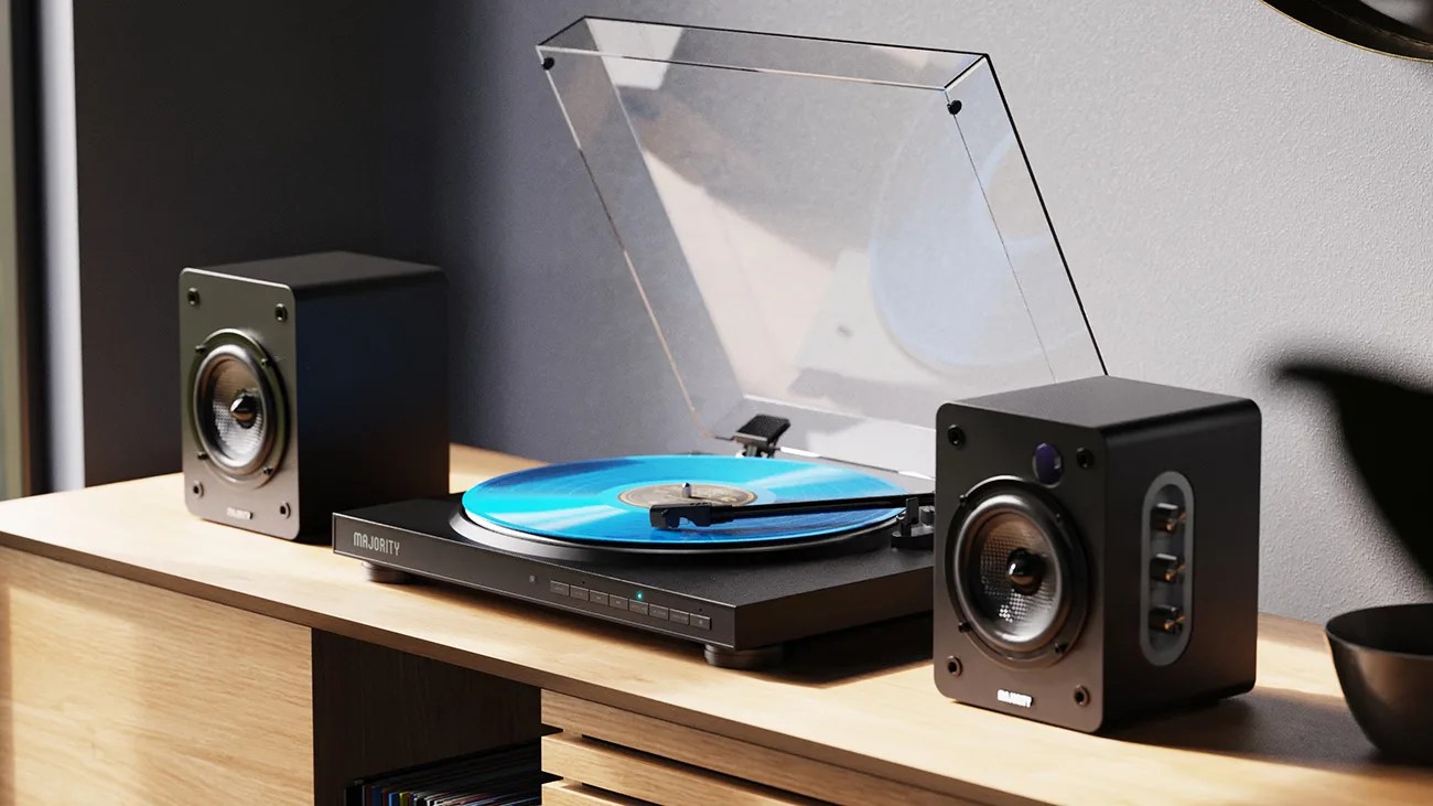 Black Majority turntable with a blue vinyl record and two black speakers on a wooden surface.