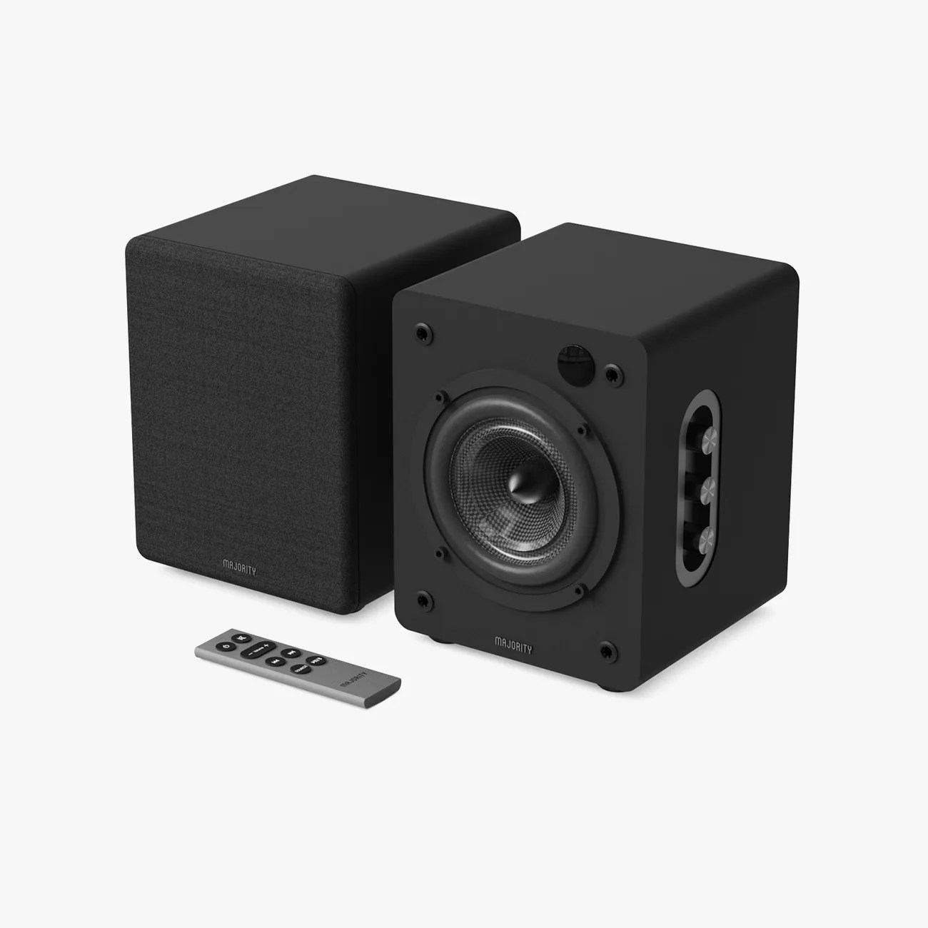 Pair of black Majority brand bookshelf speakers with one speaker grill removed and a silver remote control.