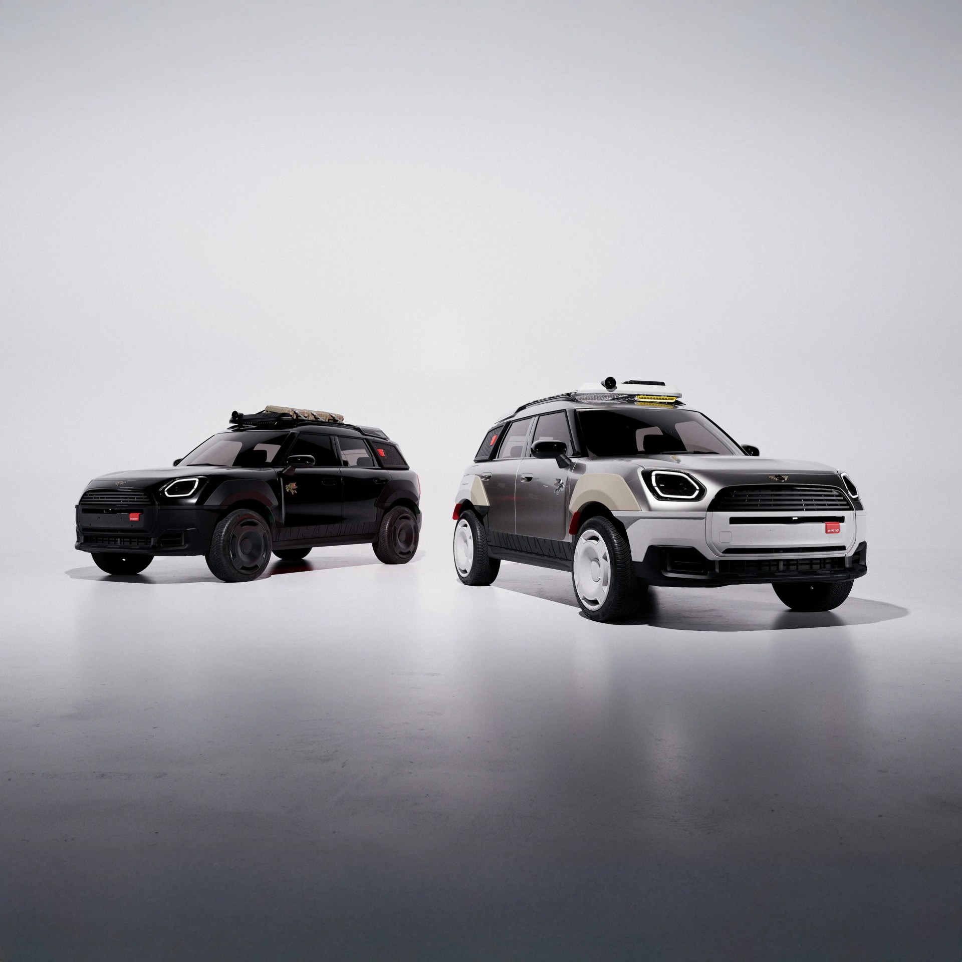 Two compact SUVs, one black and one silver with beige accents, both with roof racks, in a white studio.
