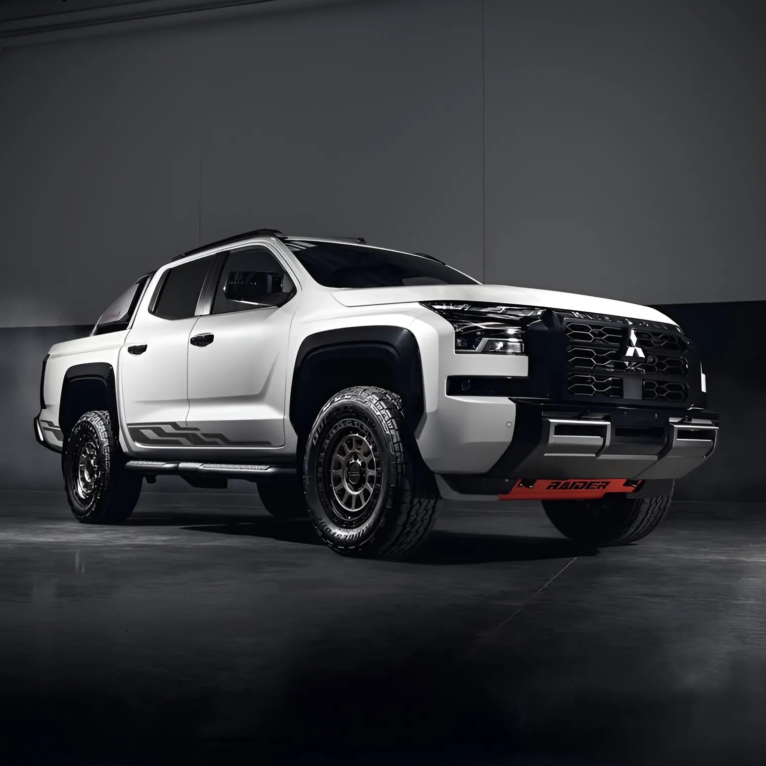 White Mitsubishi Raider pickup truck with black grille and off-road tires in a dark studio.