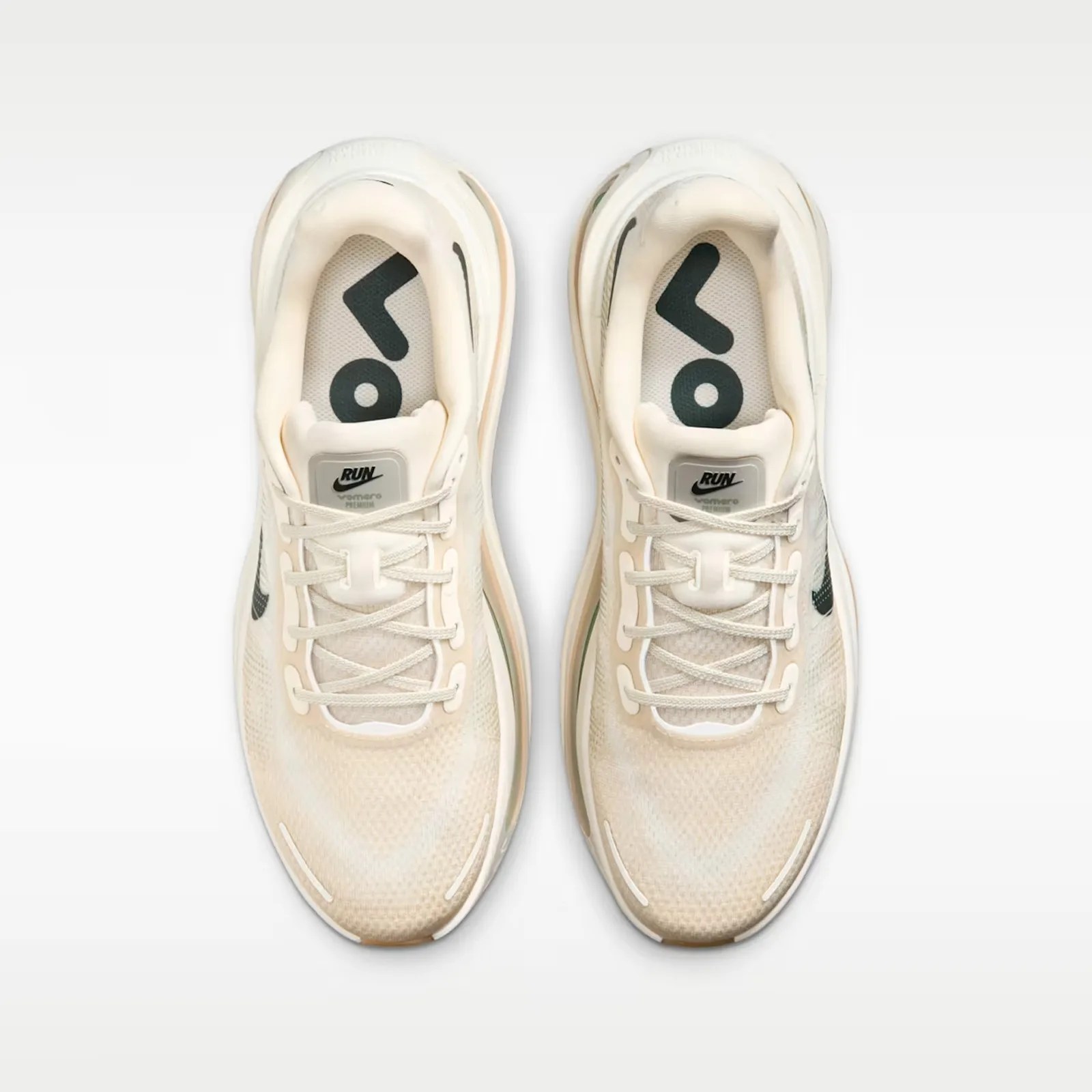 Pair of off-white Nike running shoes with black swoosh logos and "RUN" labels on the tongues.