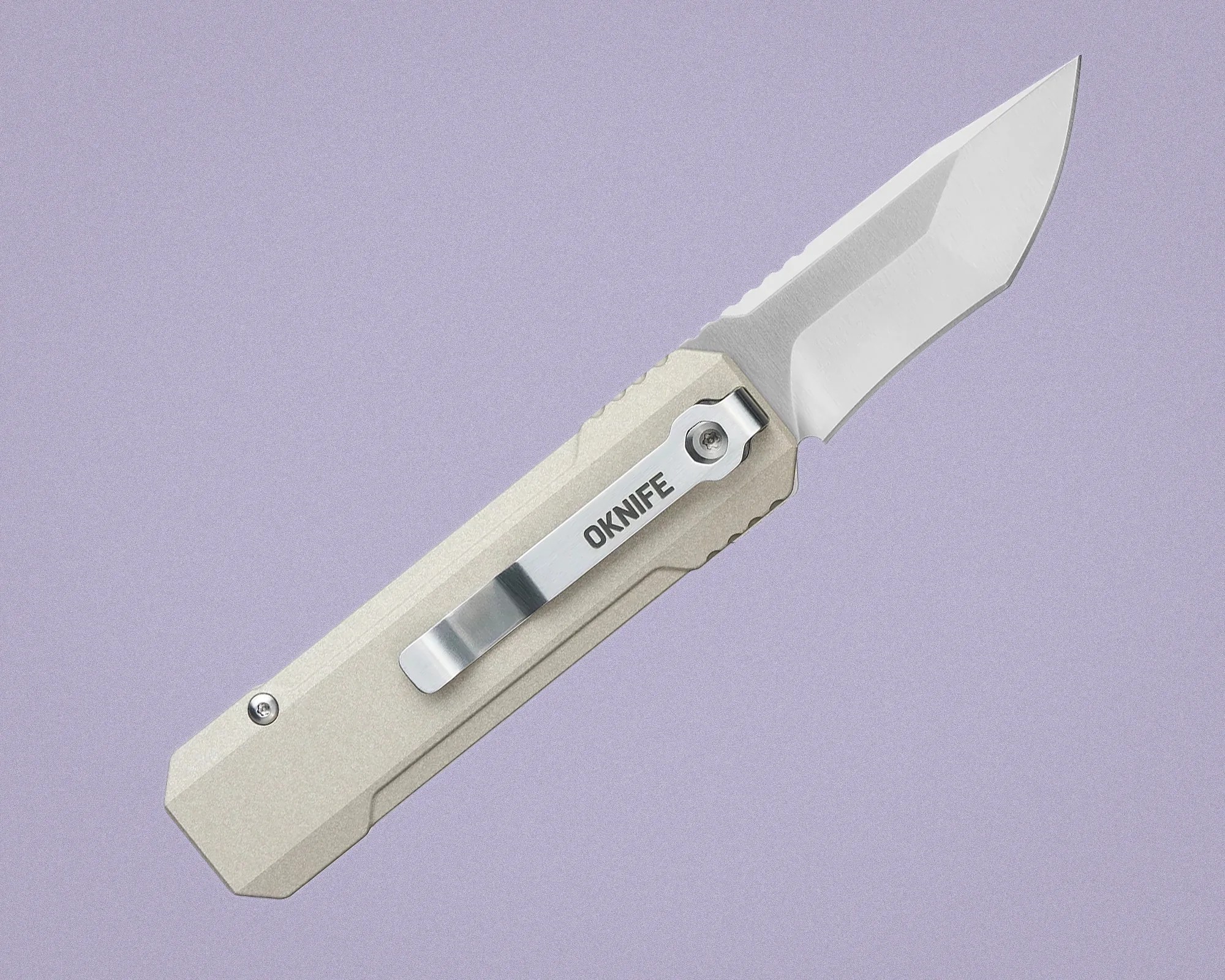 Beige folding knife with a silver clip labeled "OKNIFE" and a partially serrated blade on a purple background.