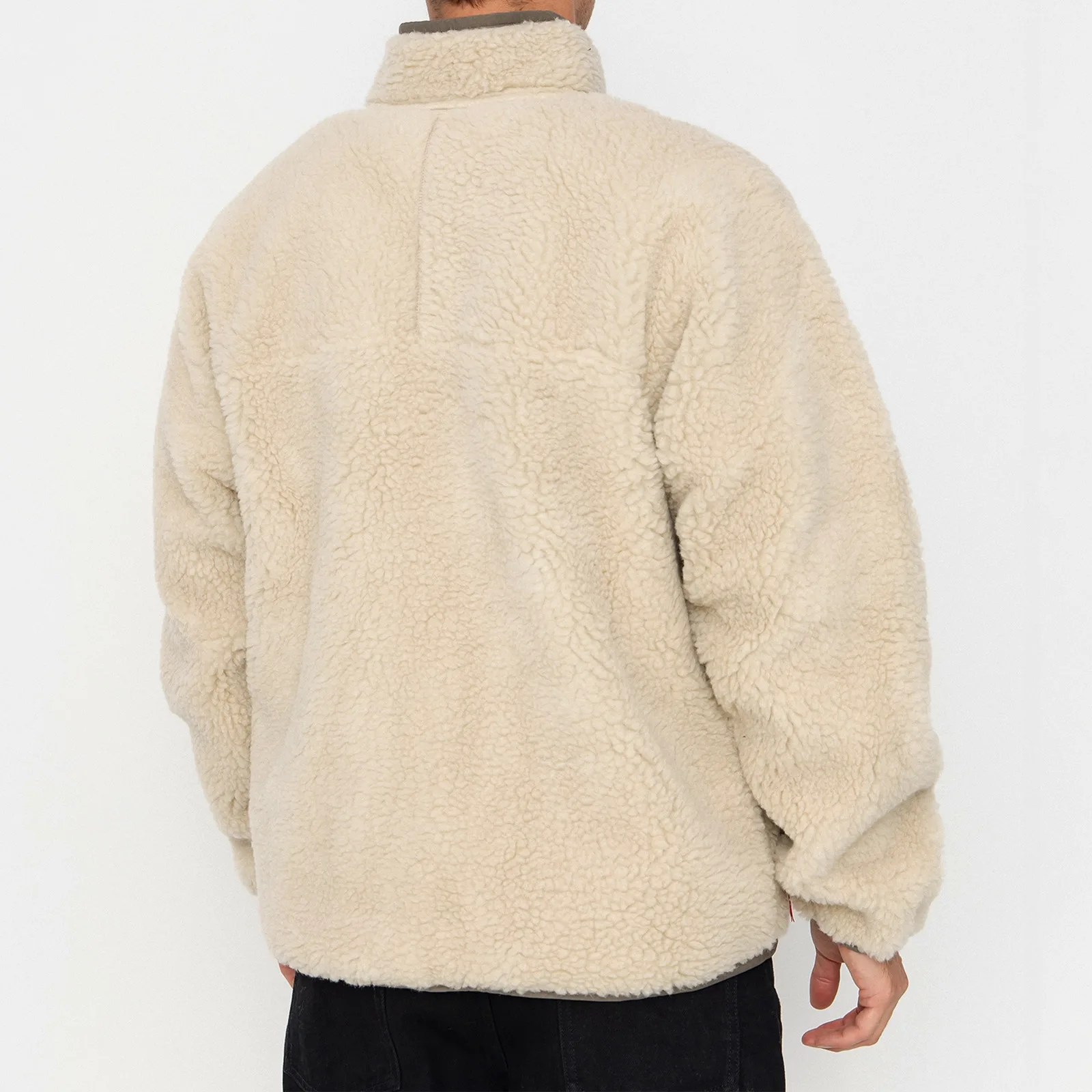 Beige sherpa fleece jacket with a high collar worn by a person, shown from the back.