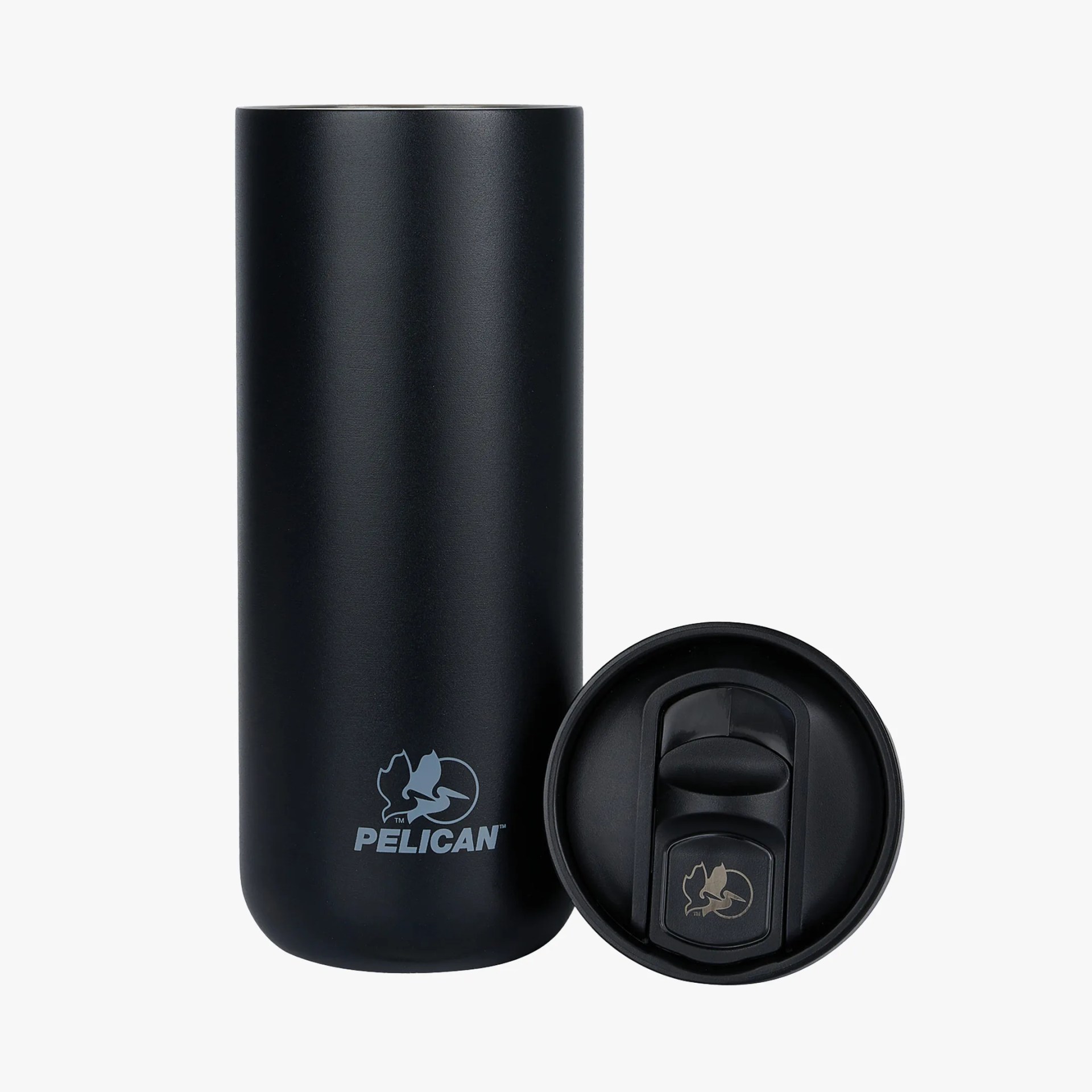 Matte black Pelican insulated tumbler with matching lid placed beside it.