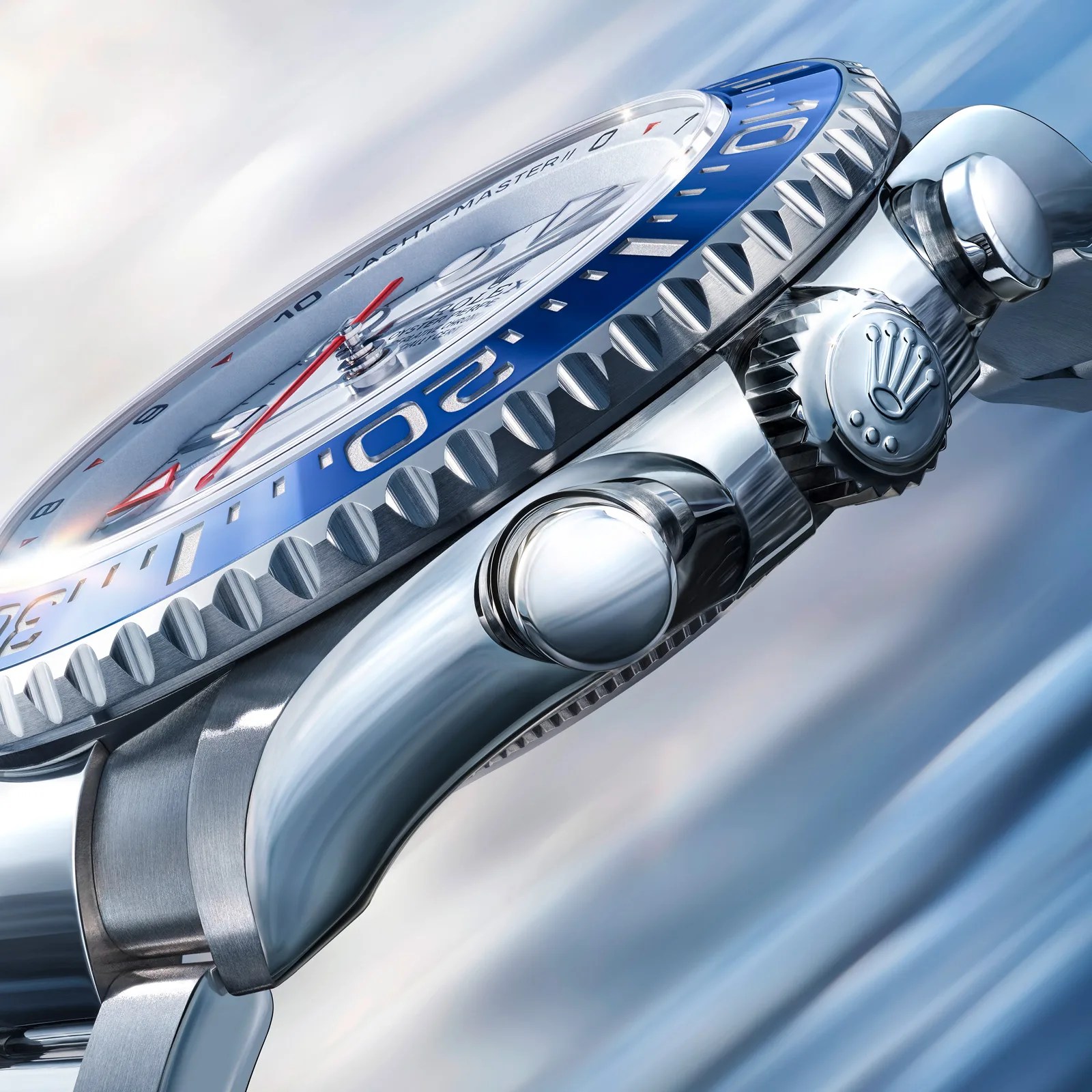 Close-up of a silver Rolex Yacht-Master II watch with a blue bezel and red second hand.