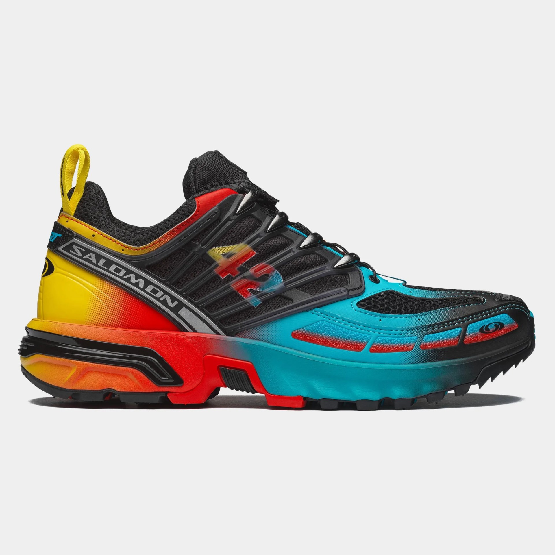 Multicolor Salomon XT-6 trail running shoe with black mesh and gradient yellow-red-blue sole.