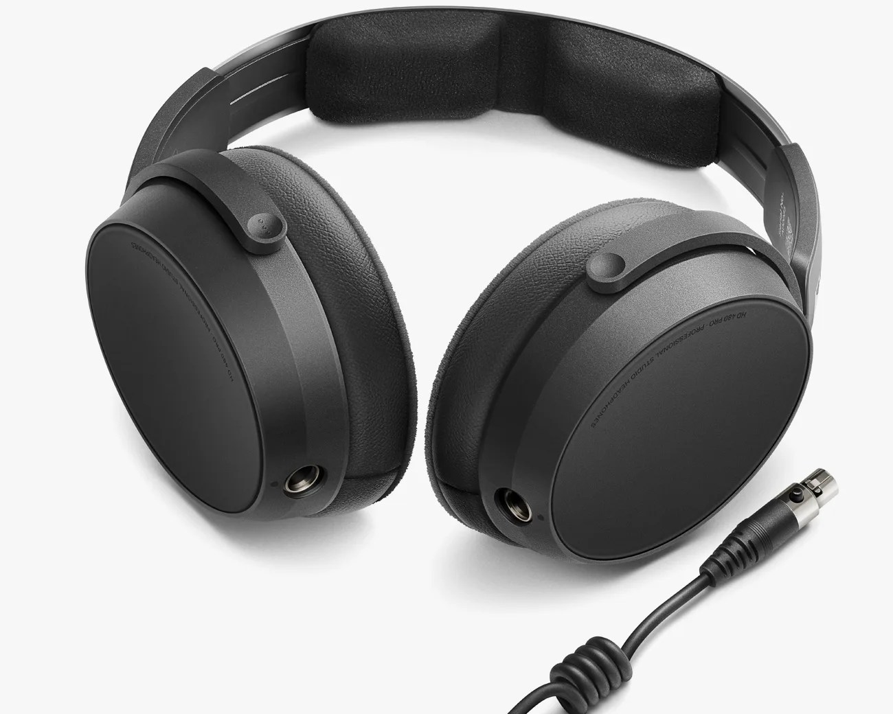 Black over-ear headphones with padded headband and detachable coiled audio cable on a white background.