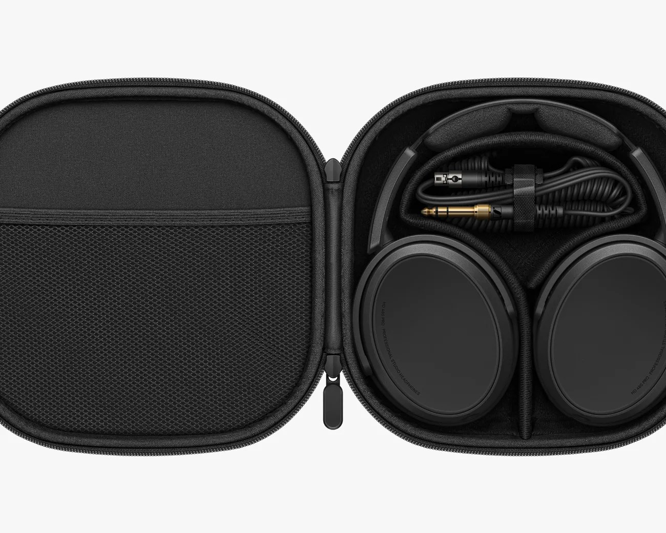Black over-ear headphones and coiled audio cable neatly stored inside a black zippered carrying case.