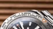 Close-up of a silver watch bezel with city names including Detroit, Chicago, Puerto Rico, and Rio de Janeiro.