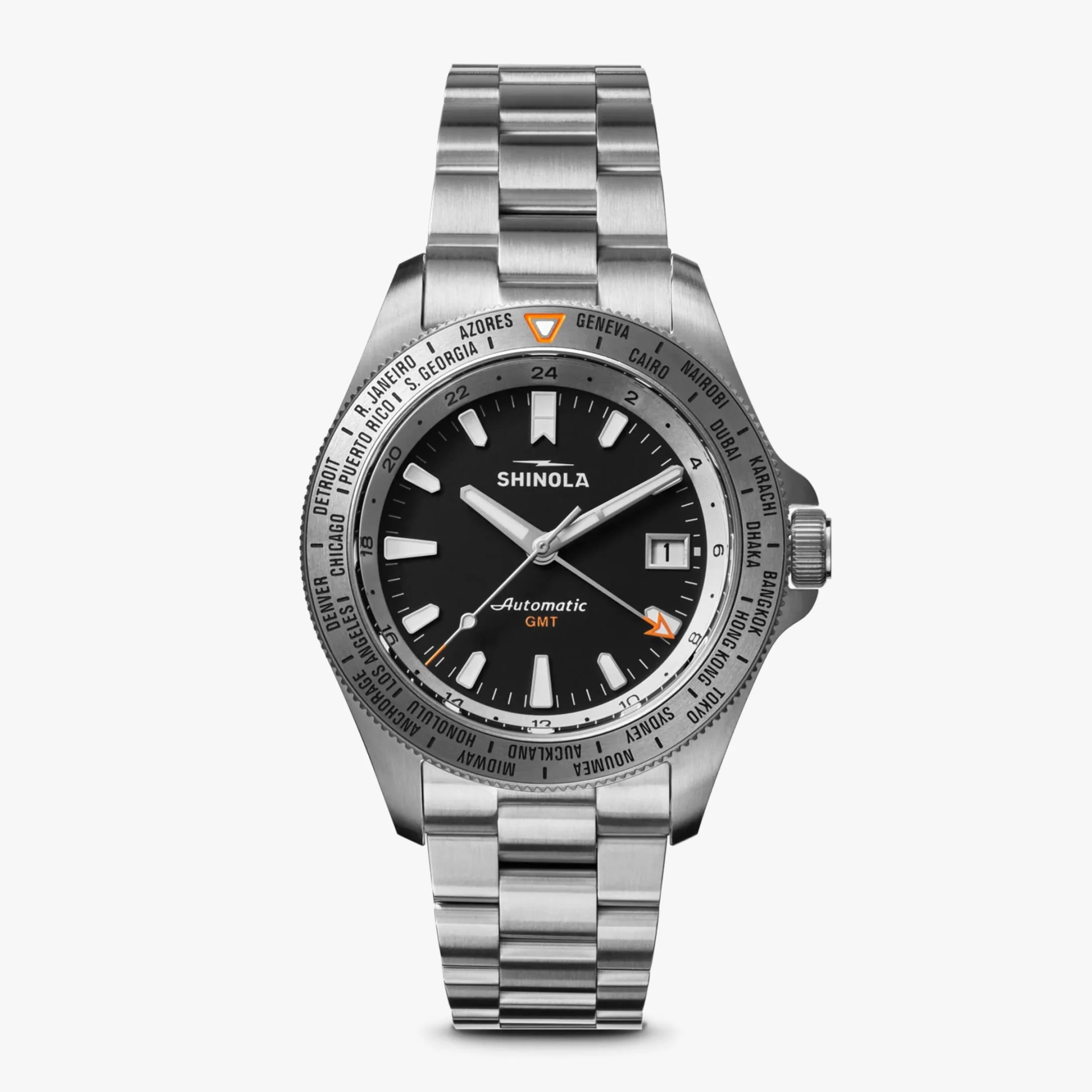 Stainless steel Shinola GMT watch with black dial, white hour markers, date window, and city names on bezel.