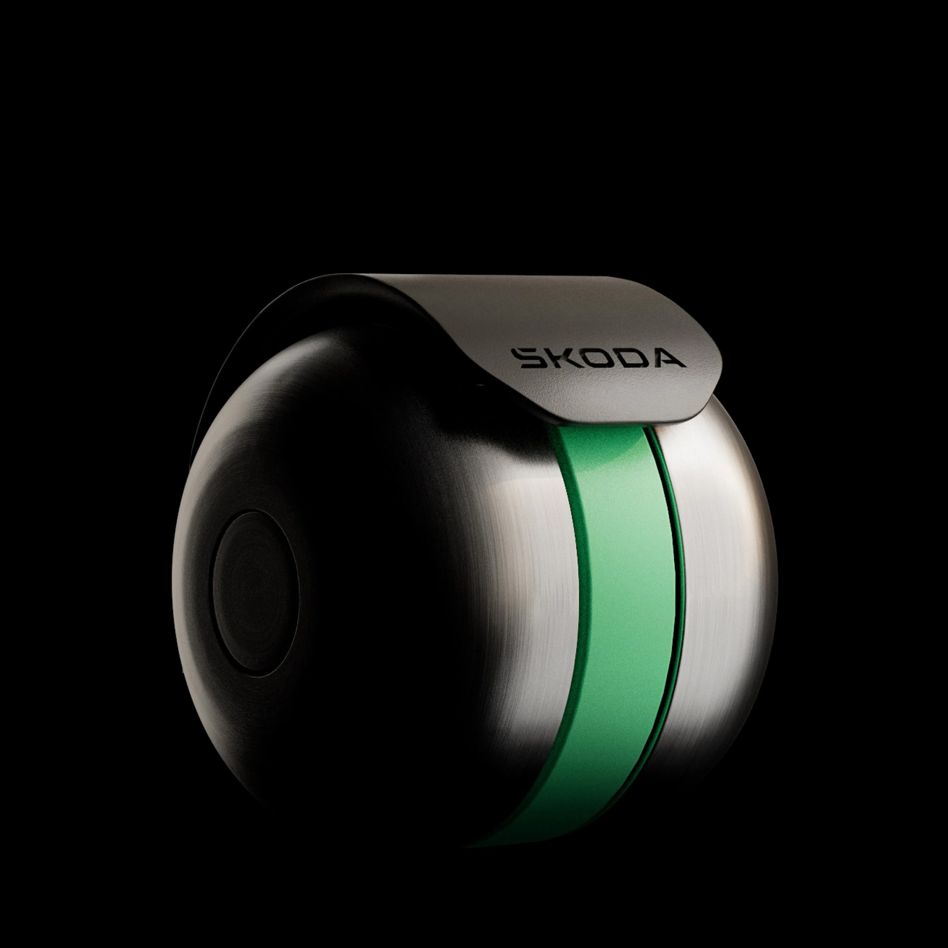 Metallic spherical object with a green stripe and a black flap labeled "SKODA" on a black background.