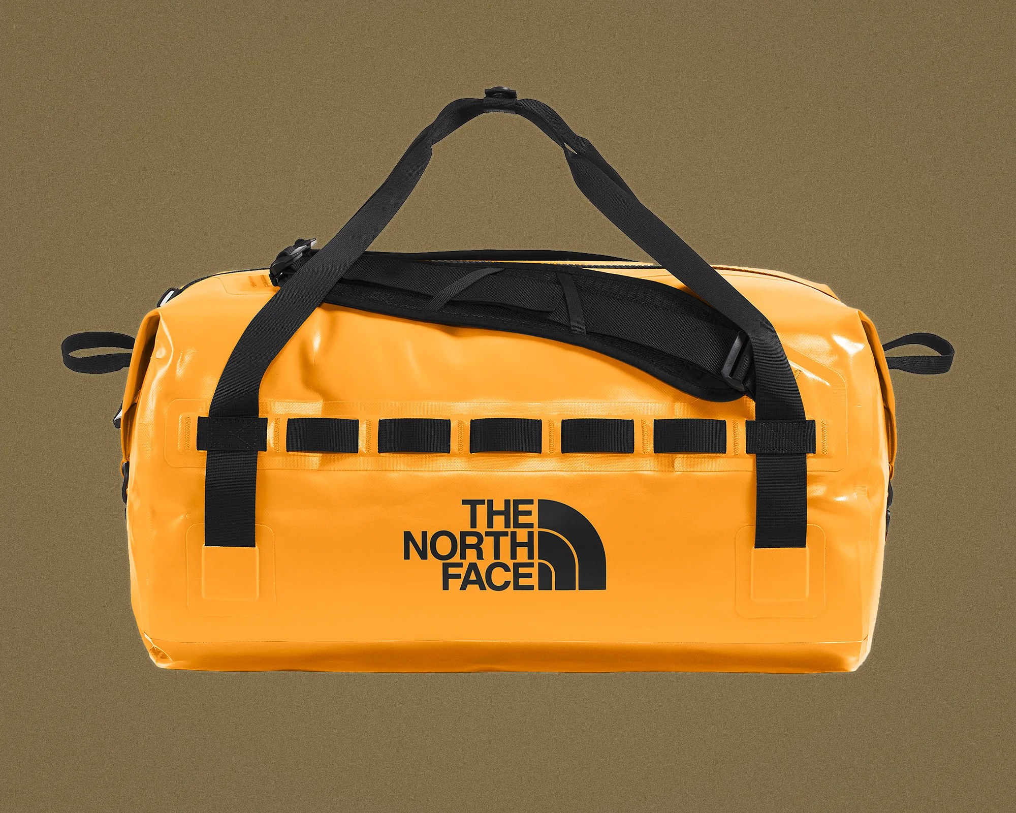 Yellow waterproof duffel bag with black straps and The North Face logo on front.