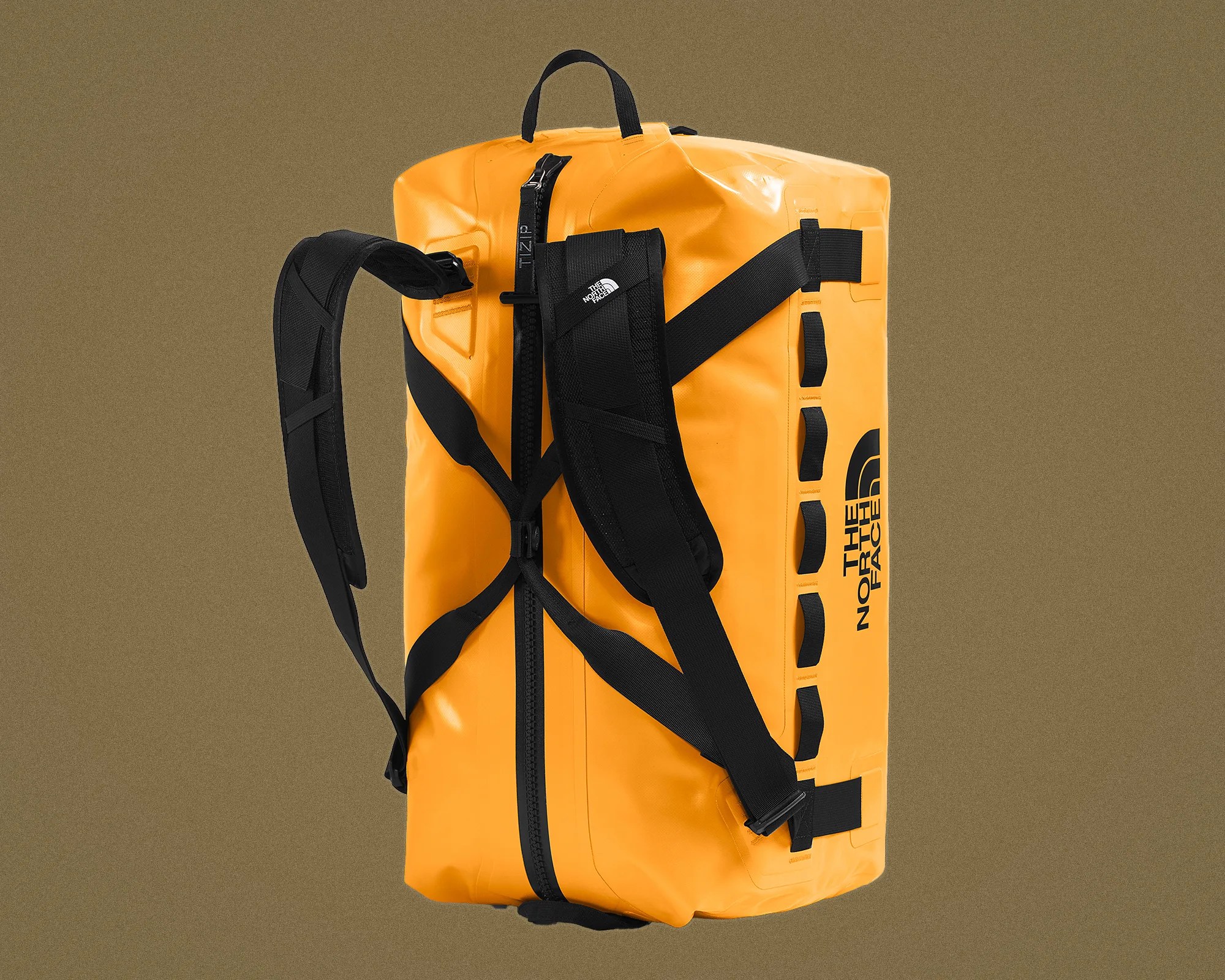 Bright orange rectangular duffel bag with black padded shoulder straps and The North Face logo on the side.