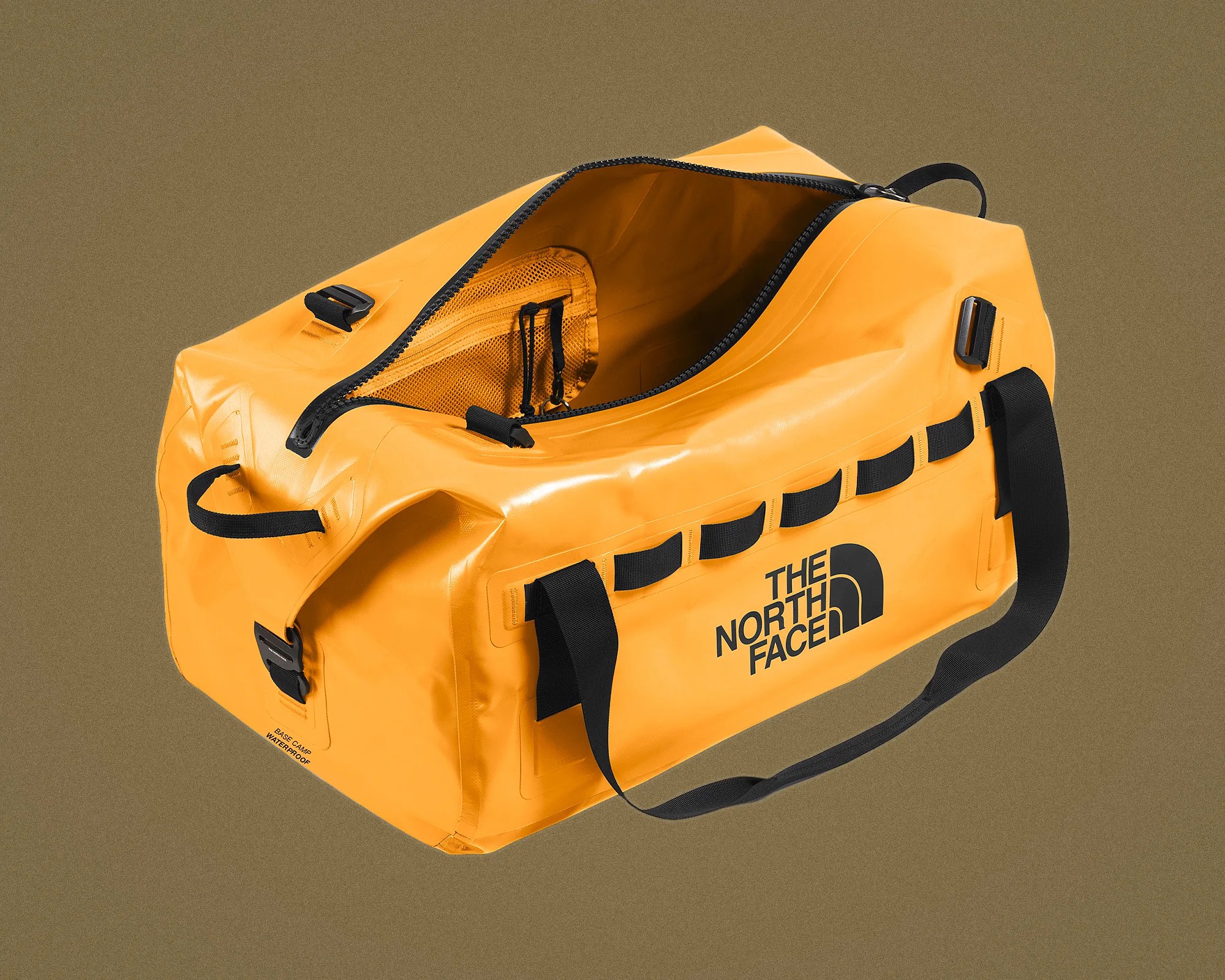 Yellow waterproof duffel bag with black handles and The North Face logo, partially open showing interior mesh pocket.