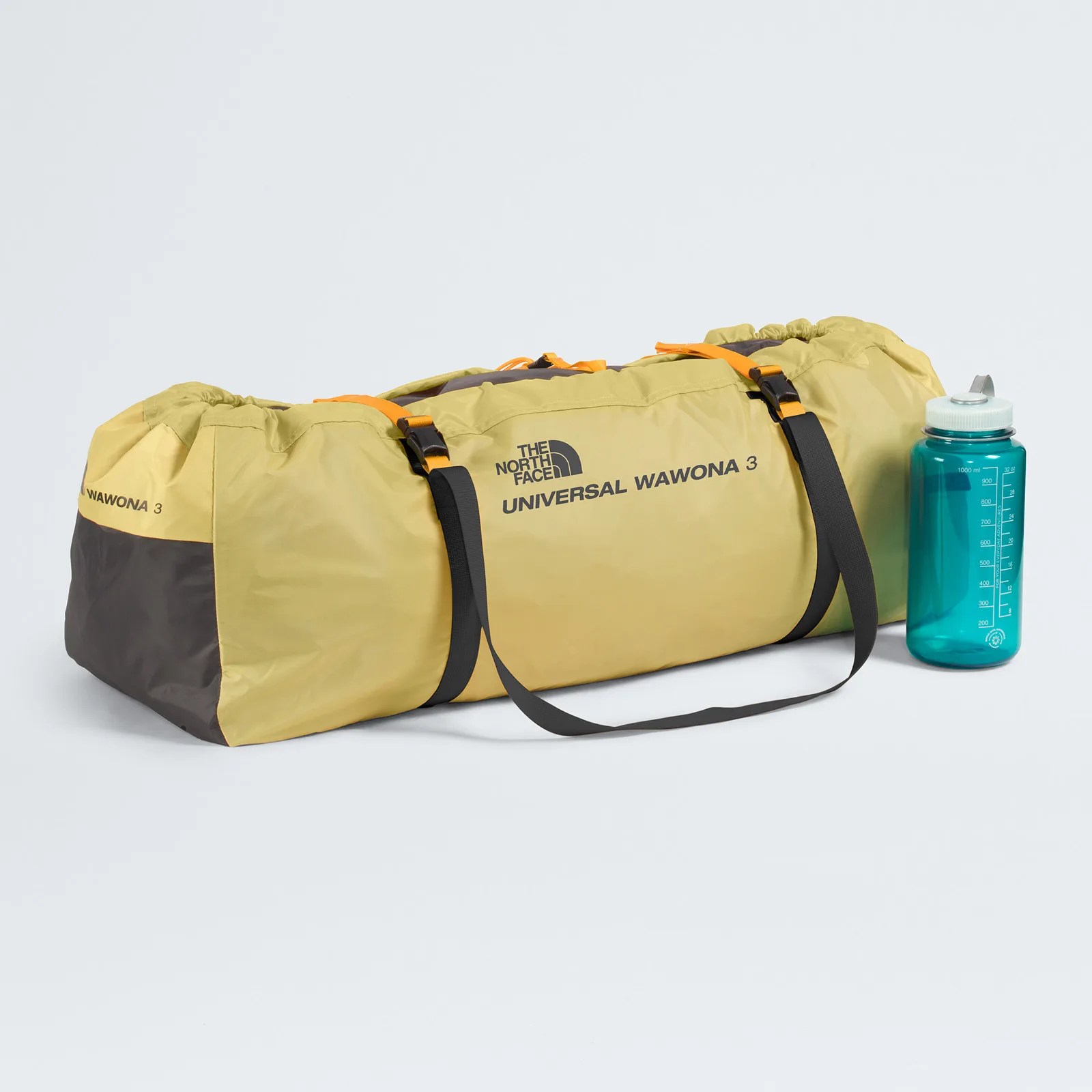 Yellow and gray The North Face Universal Wawona 3 duffel bag with black straps next to a blue water bottle.
