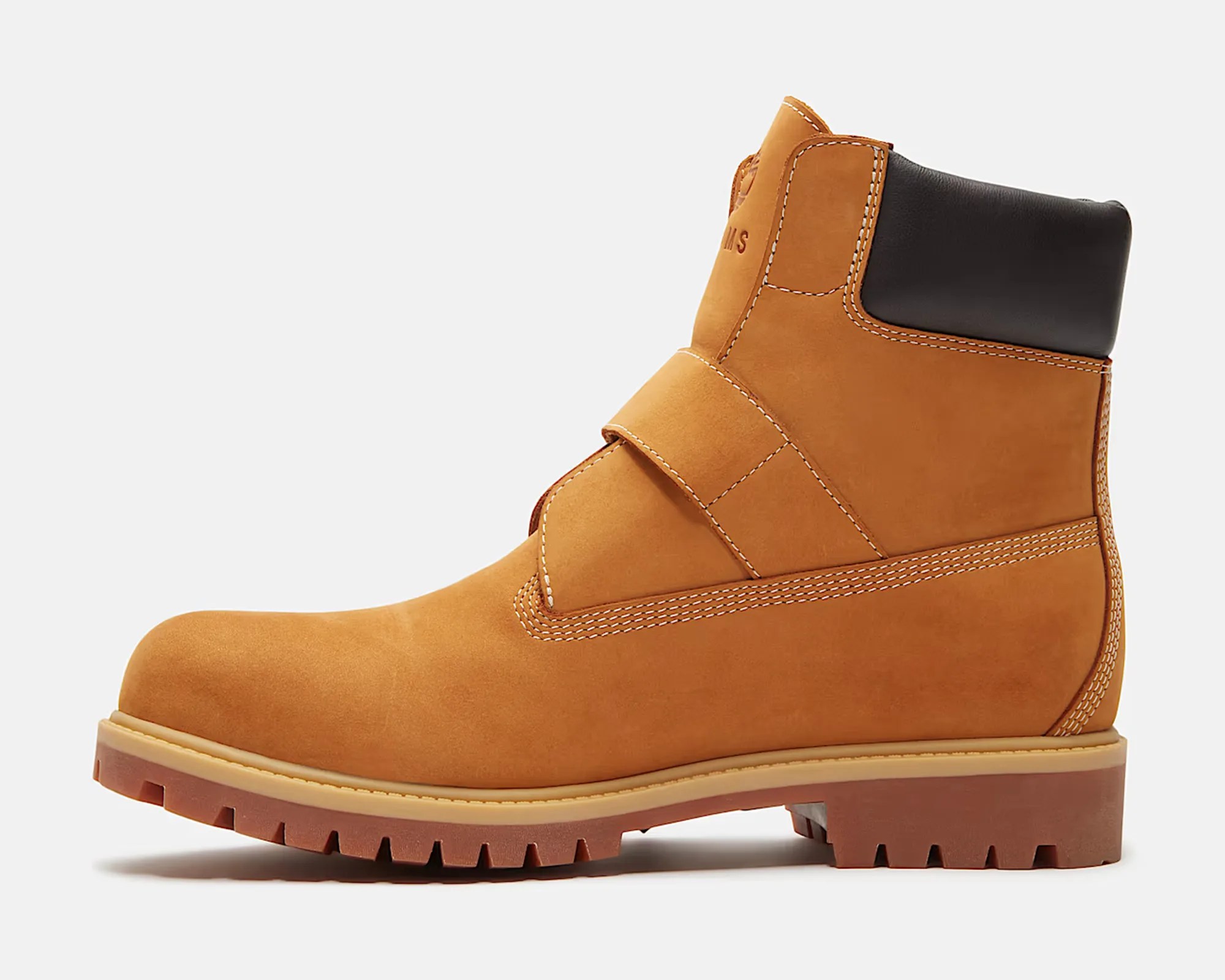 Tan leather ankle boot with black padded collar and rugged brown sole.