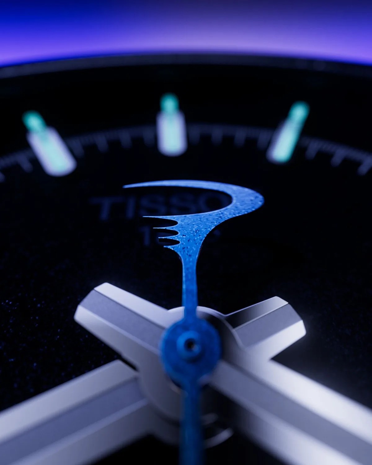 Close-up of a watch face showing a blue second hand with a unique curved design and silver hour and minute hands.