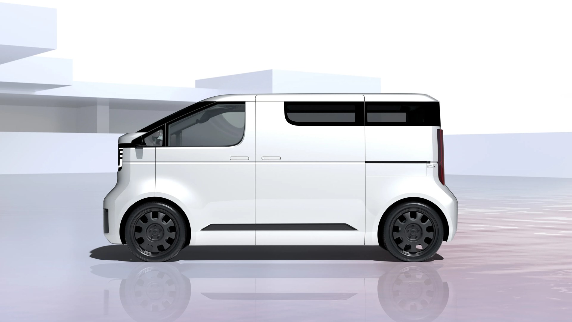 White compact electric van with black-tinted windows and black wheels on a reflective surface.