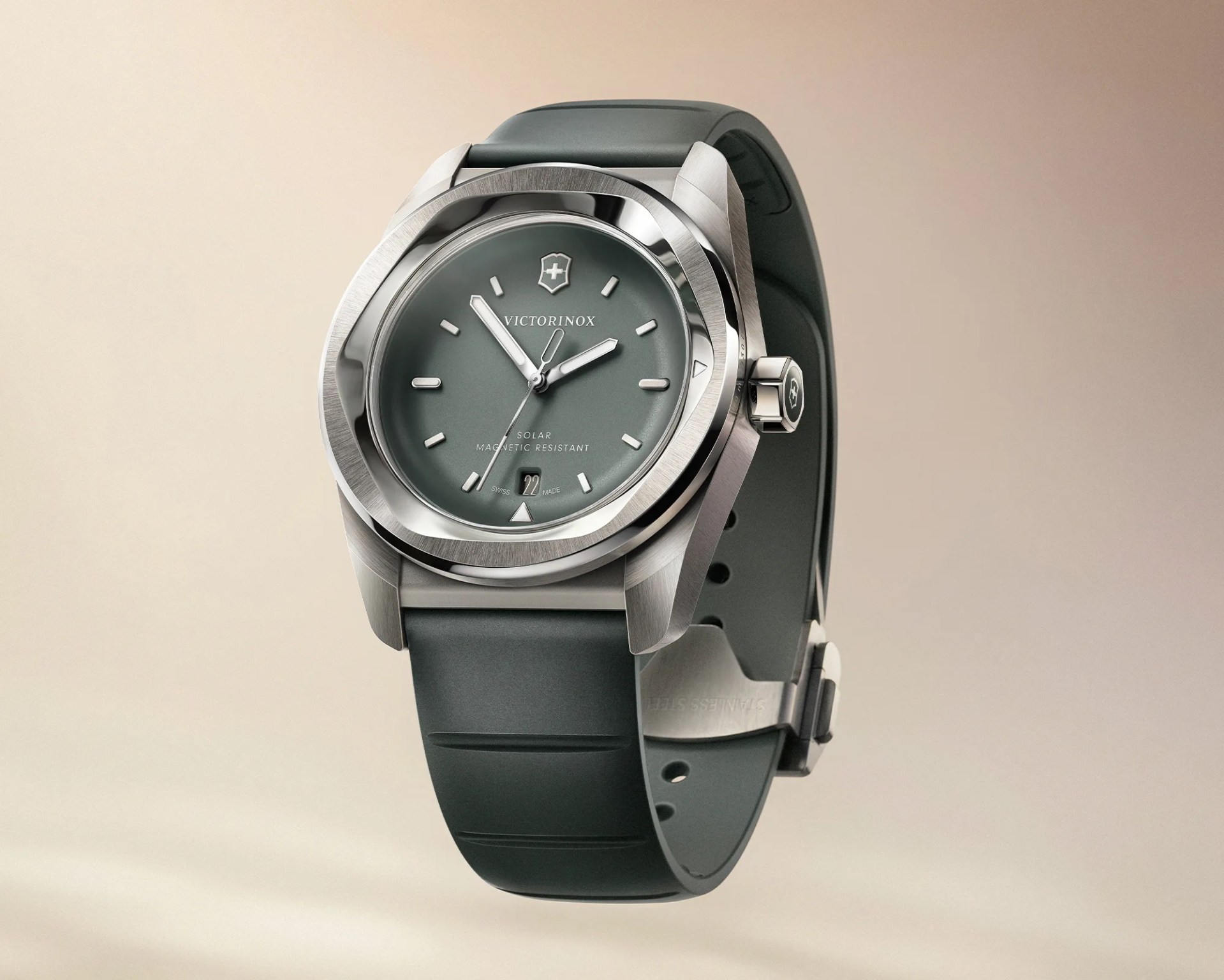 Victorinox wristwatch with a green dial, silver markers, stainless steel case, and green rubber strap.
