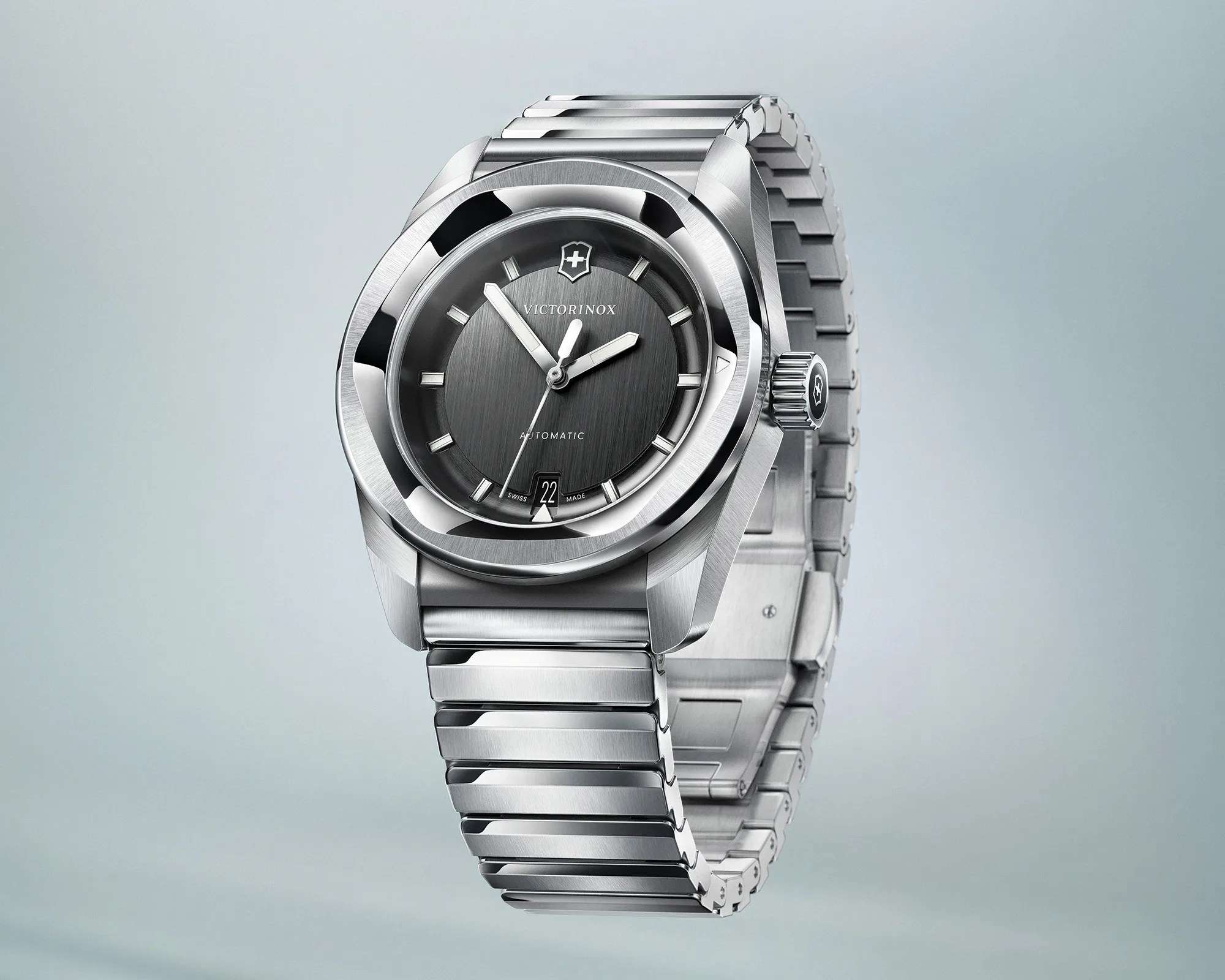 Silver stainless steel Victorinox wristwatch with black dial and date display at 6 o'clock.