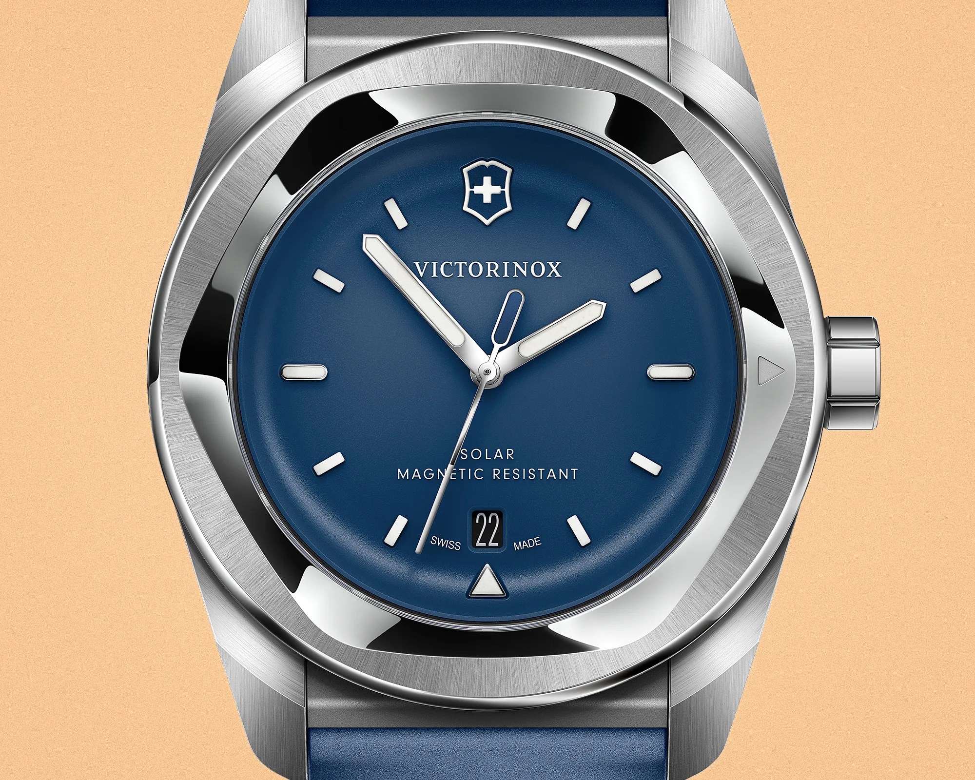 Close-up of a Victorinox wristwatch with a blue dial, silver markers, date window, and stainless steel case.