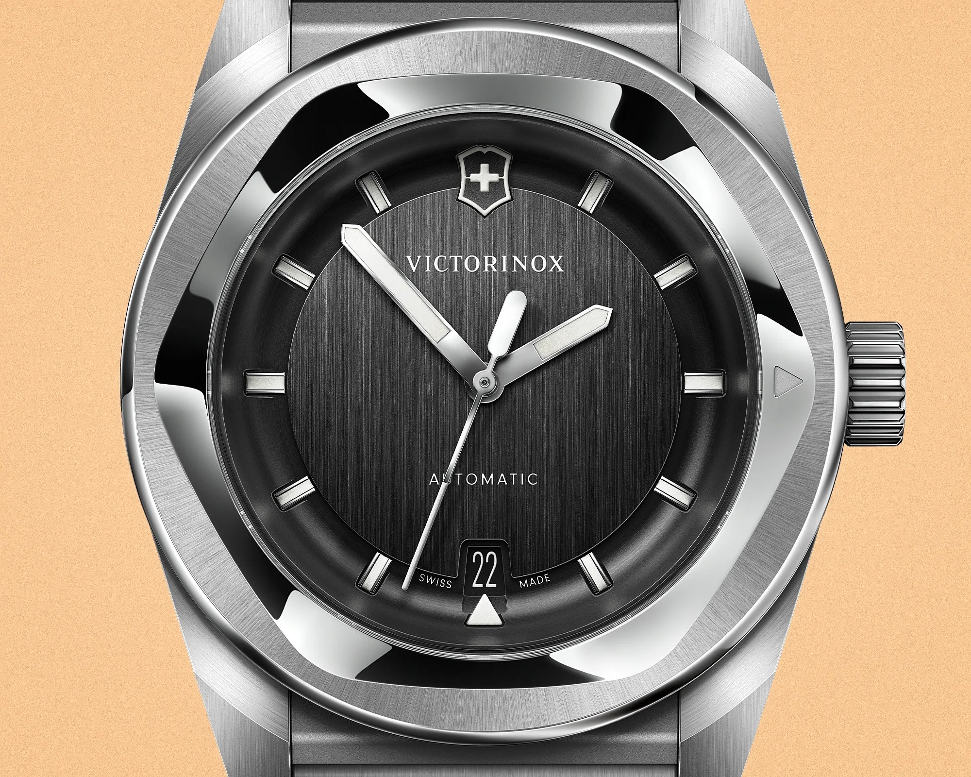 Close-up of a Victorinox automatic wristwatch with a black textured dial, silver hour markers, and a date window at 6 o'clock.